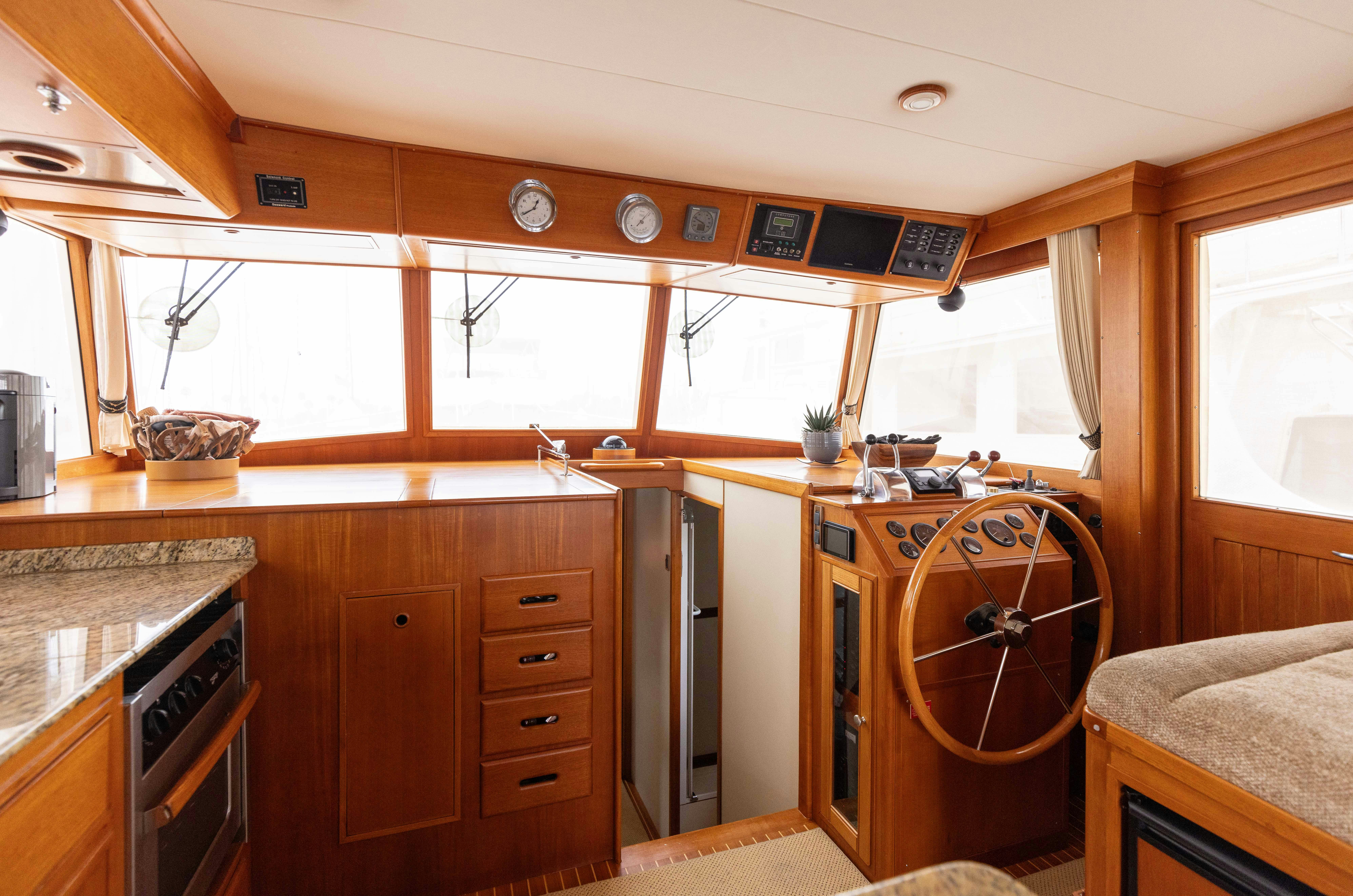 a kitchen with wooden cabinets aboard INDABA Yacht for Sale