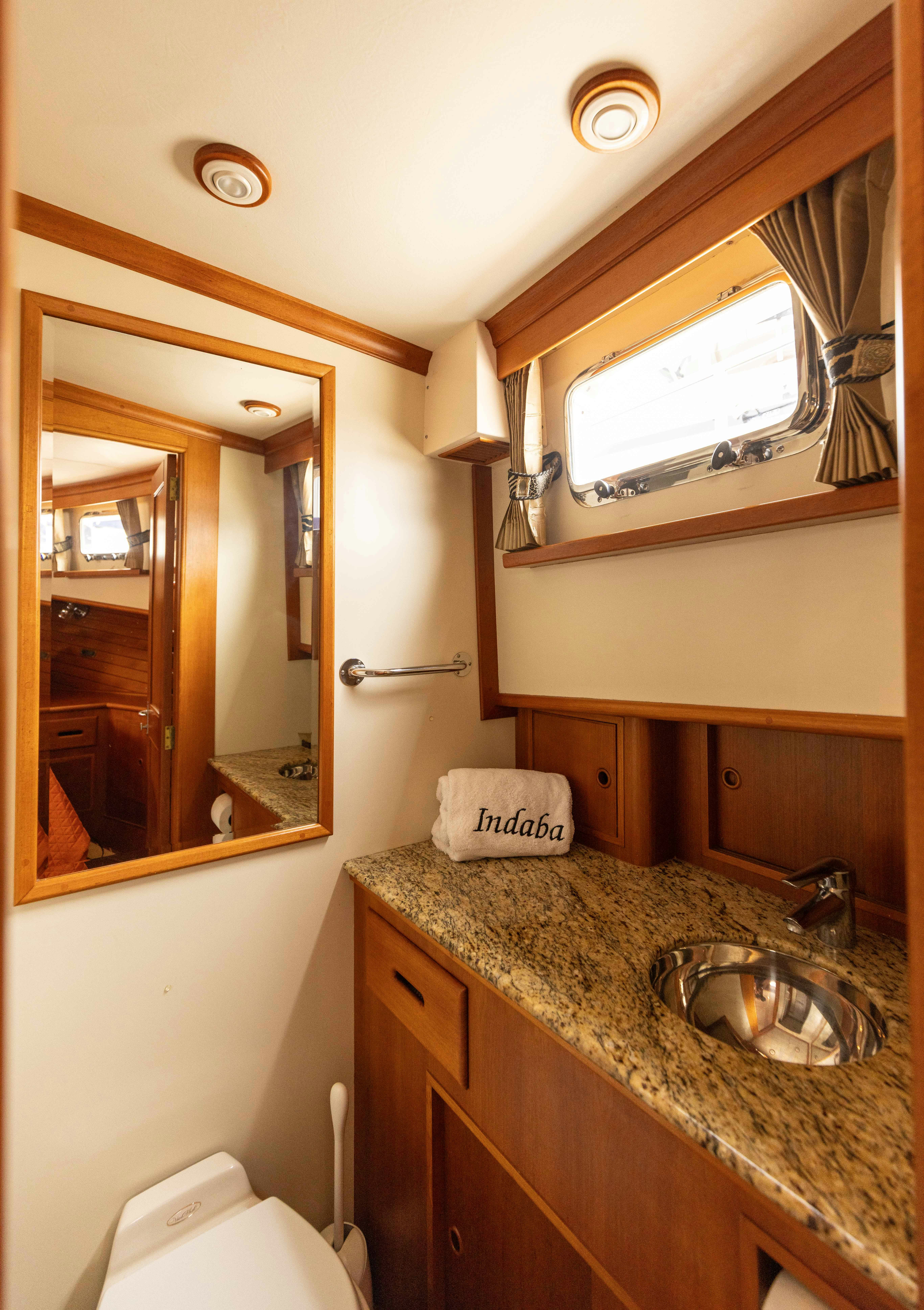 a bathroom with a sink and a mirror aboard INDABA Yacht for Sale