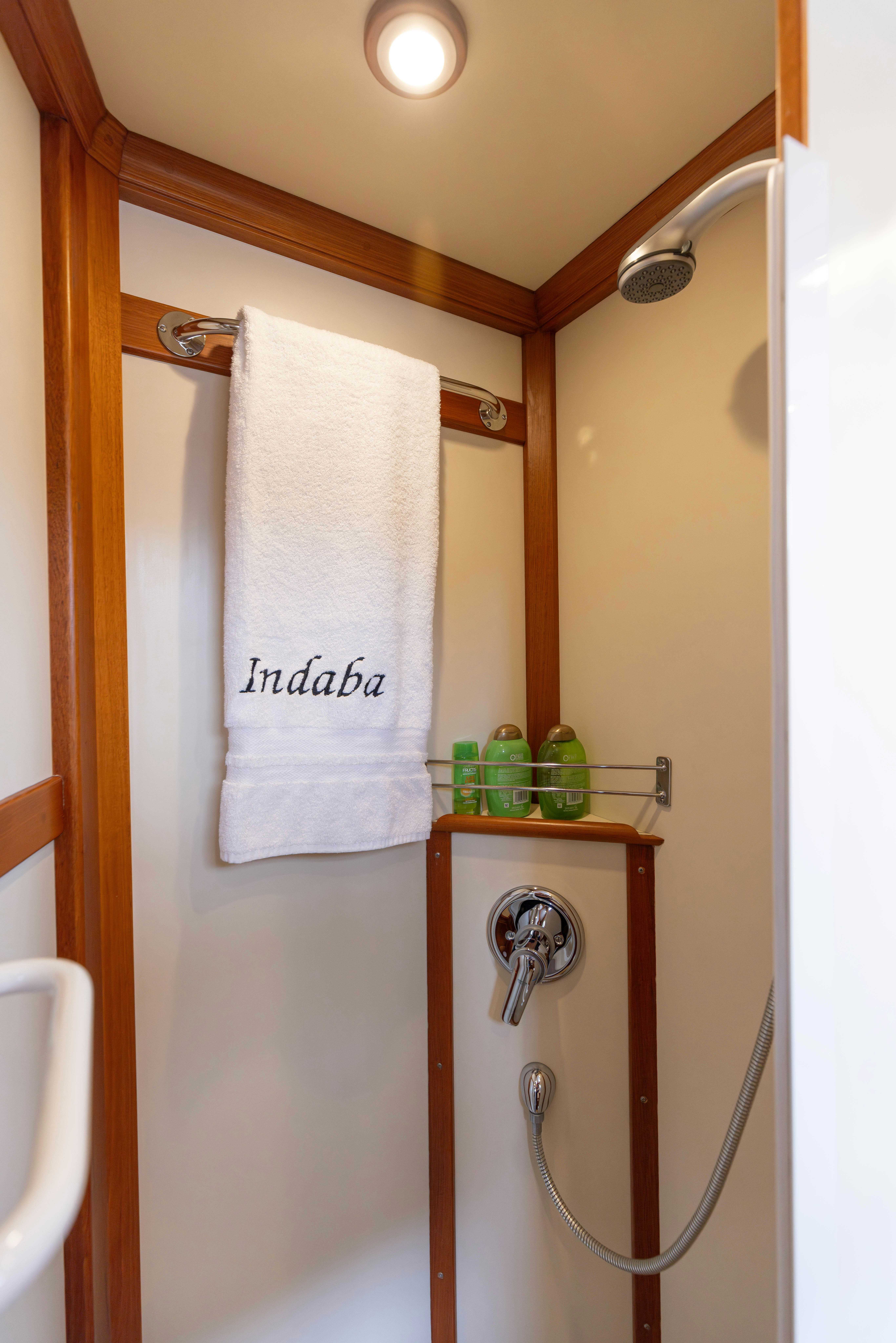 a shower with a towel on the wall aboard INDABA Yacht for Sale