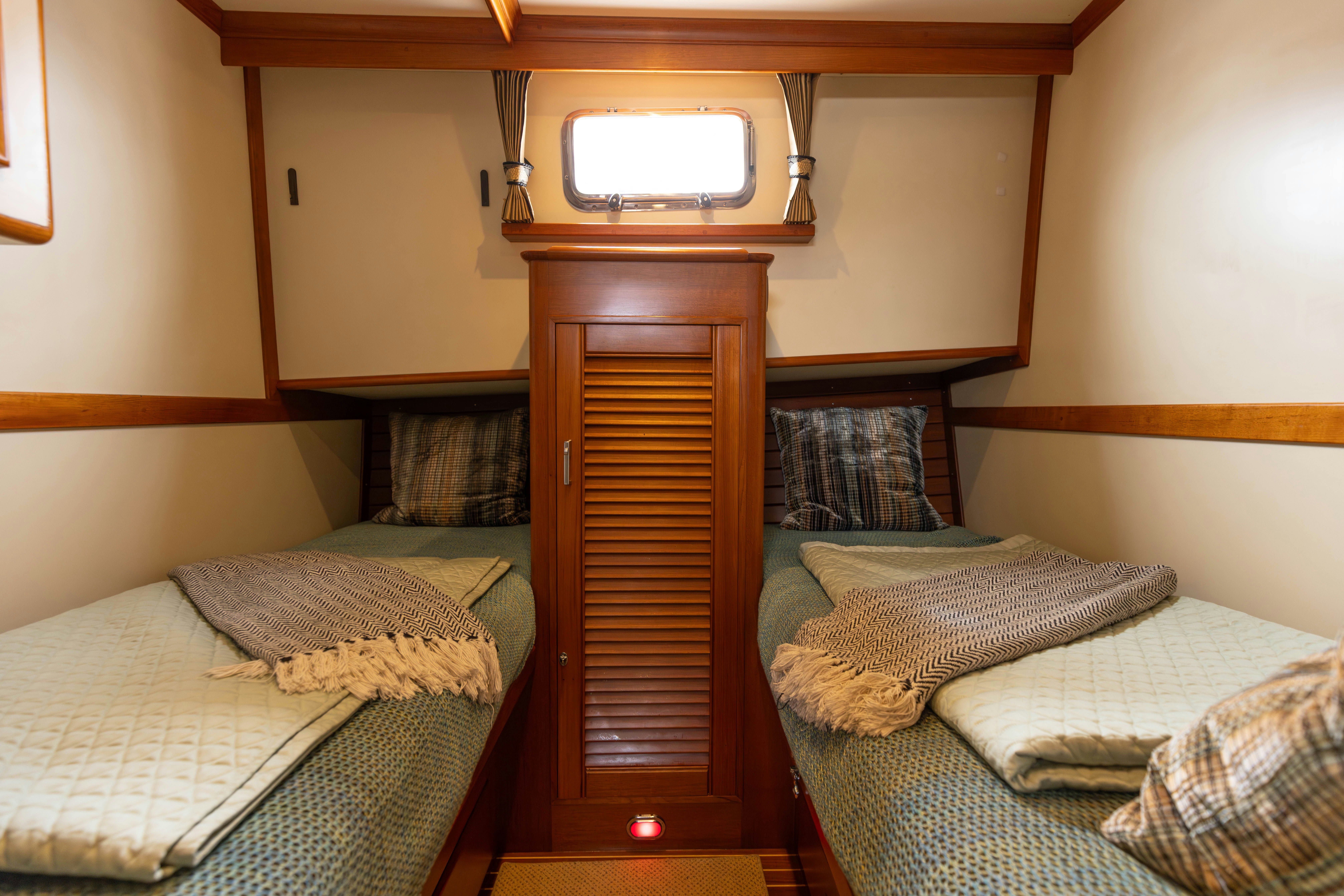 a bed with a mirror above it aboard INDABA Yacht for Sale
