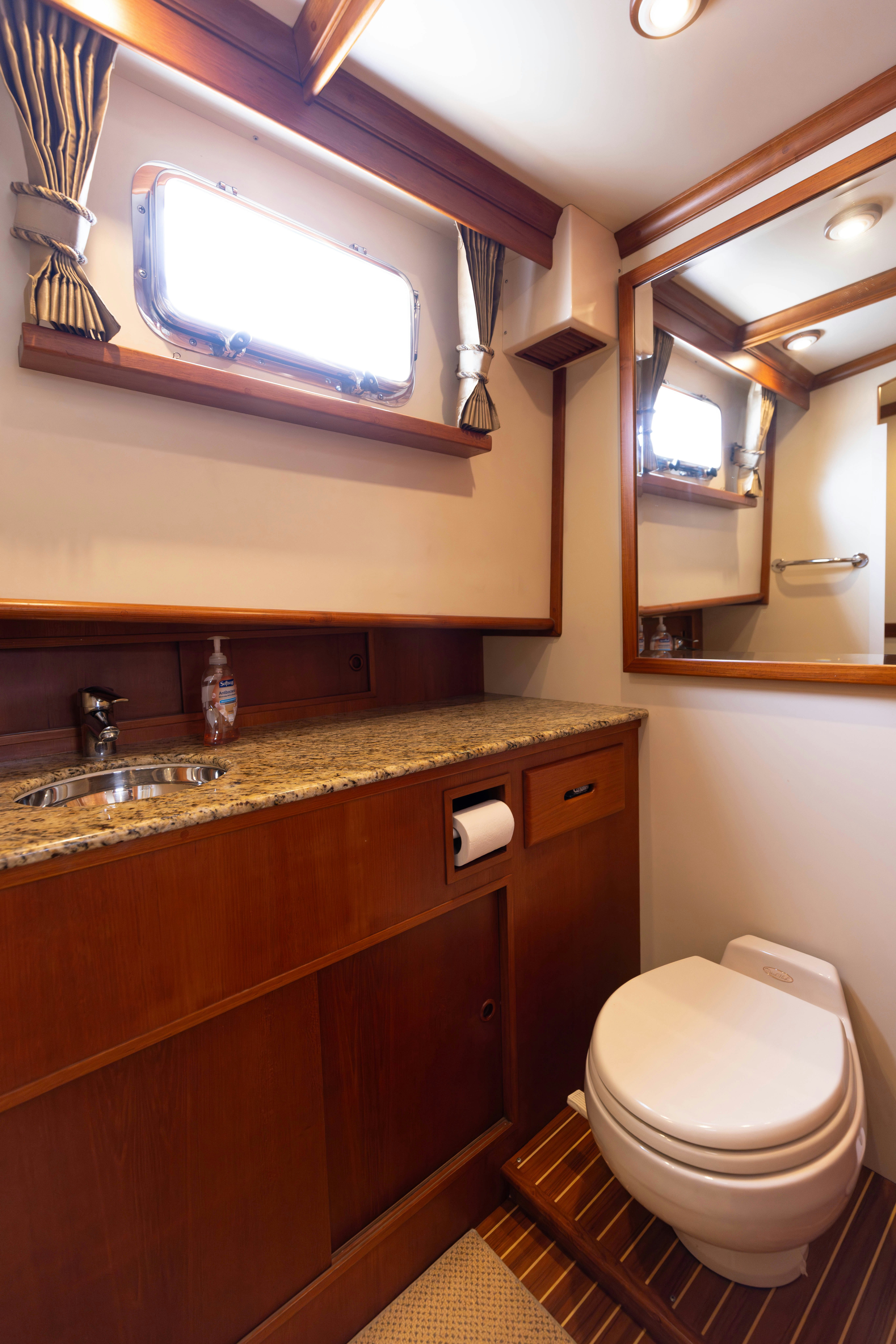 a bathroom with a toilet and a sink aboard INDABA Yacht for Sale