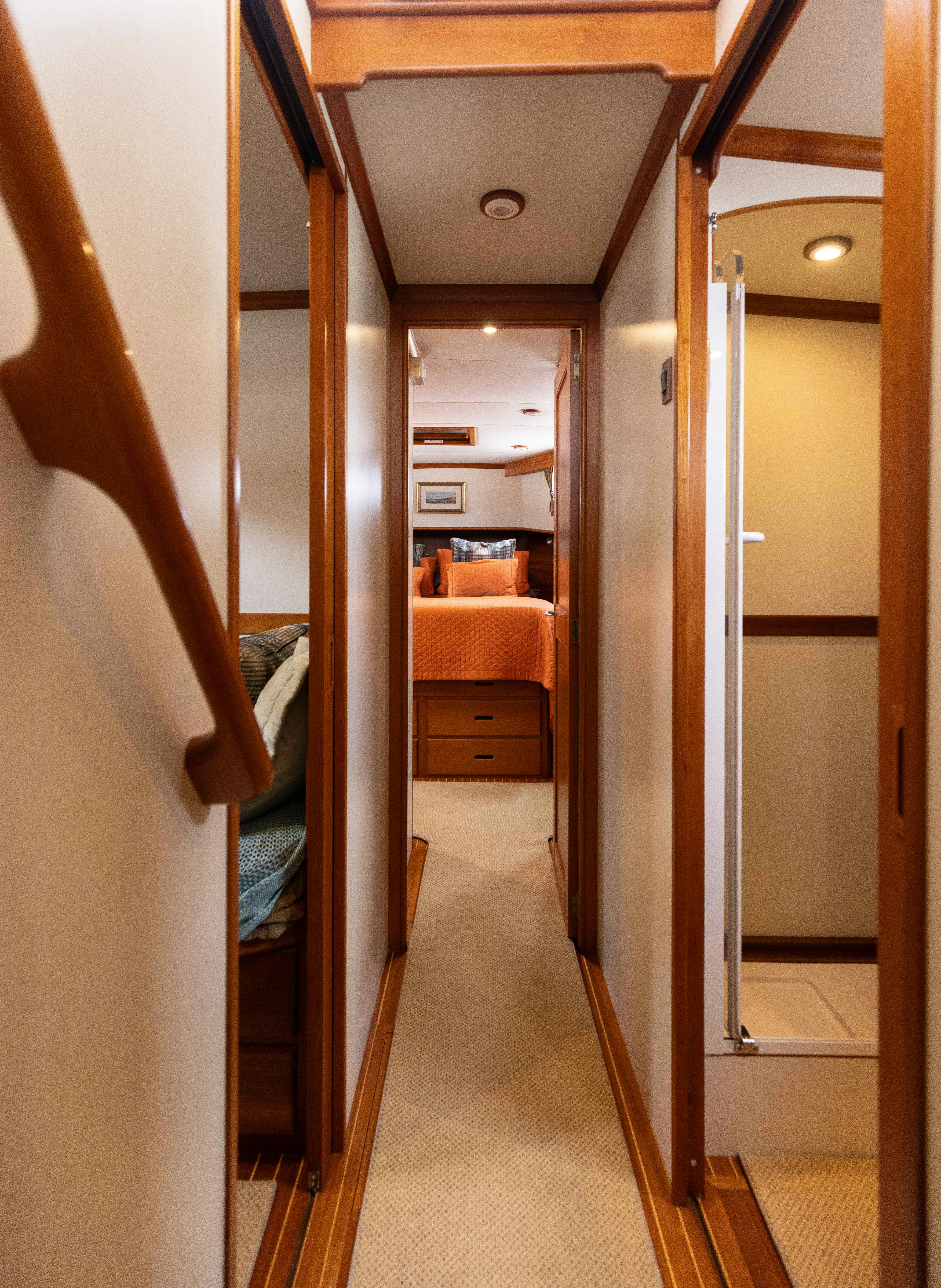 a hallway with a bed and a door aboard INDABA Yacht for Sale