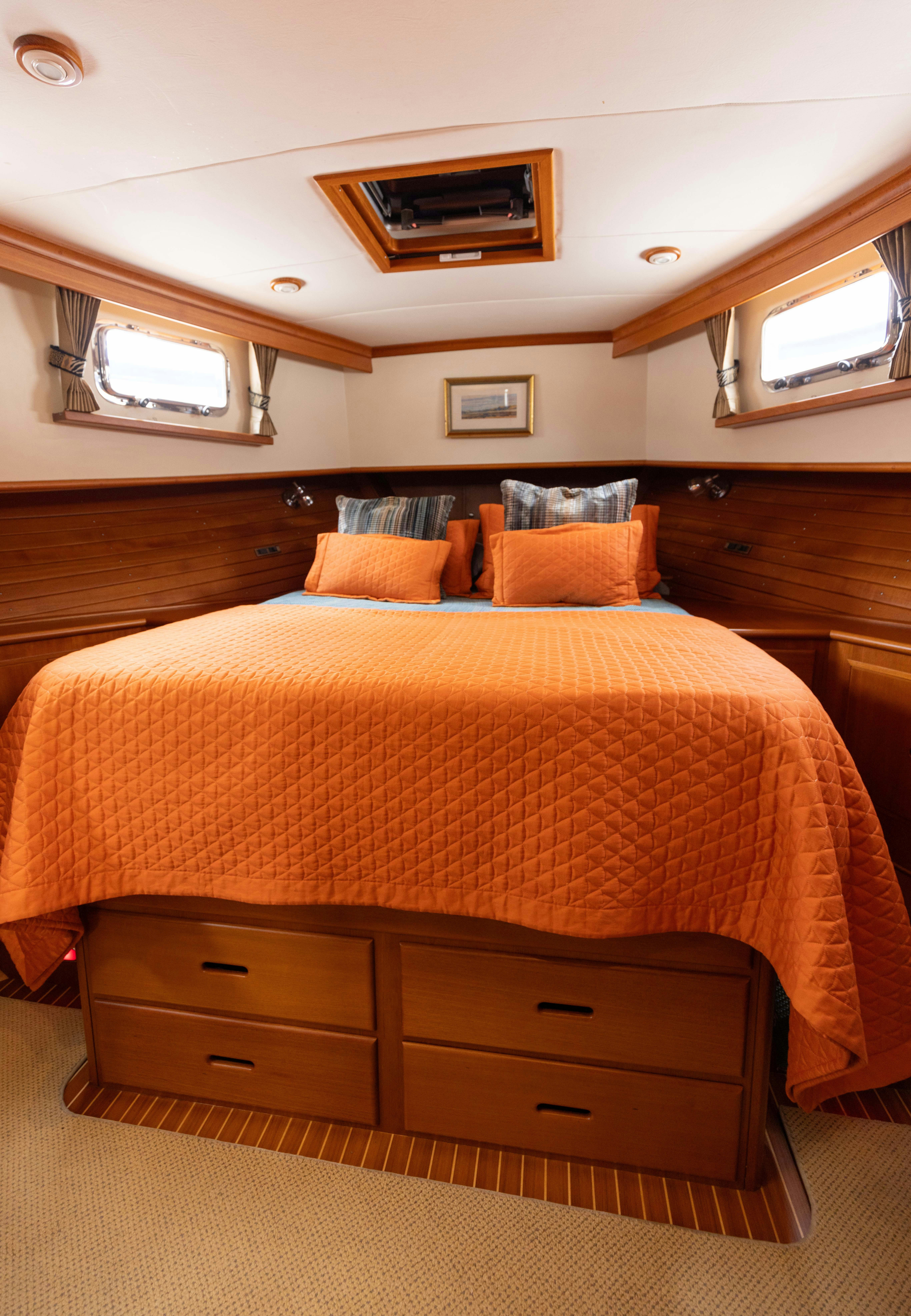 a bed with a yellow comforter aboard INDABA Yacht for Sale