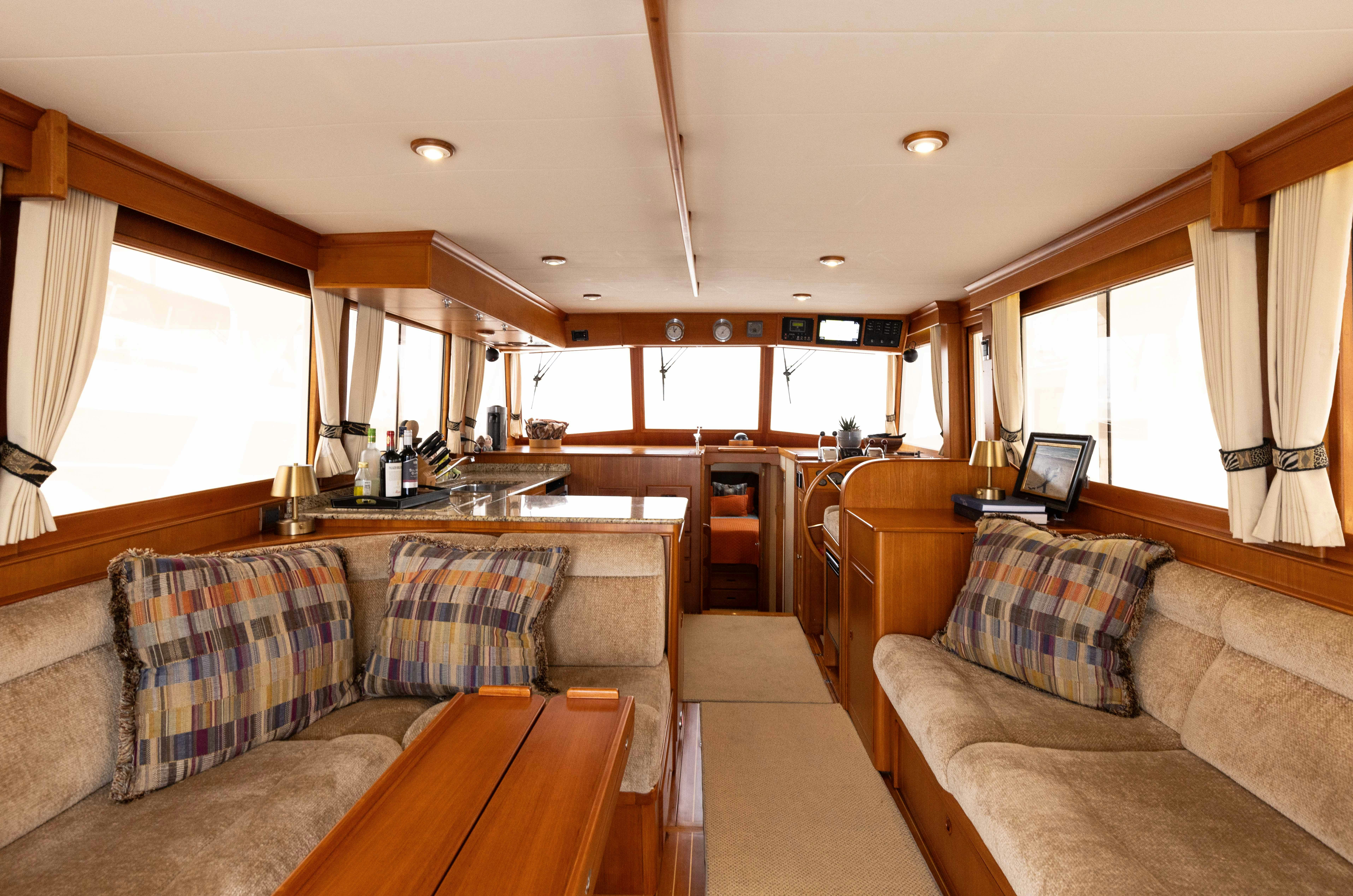 a living room with a couch and a table aboard INDABA Yacht for Sale