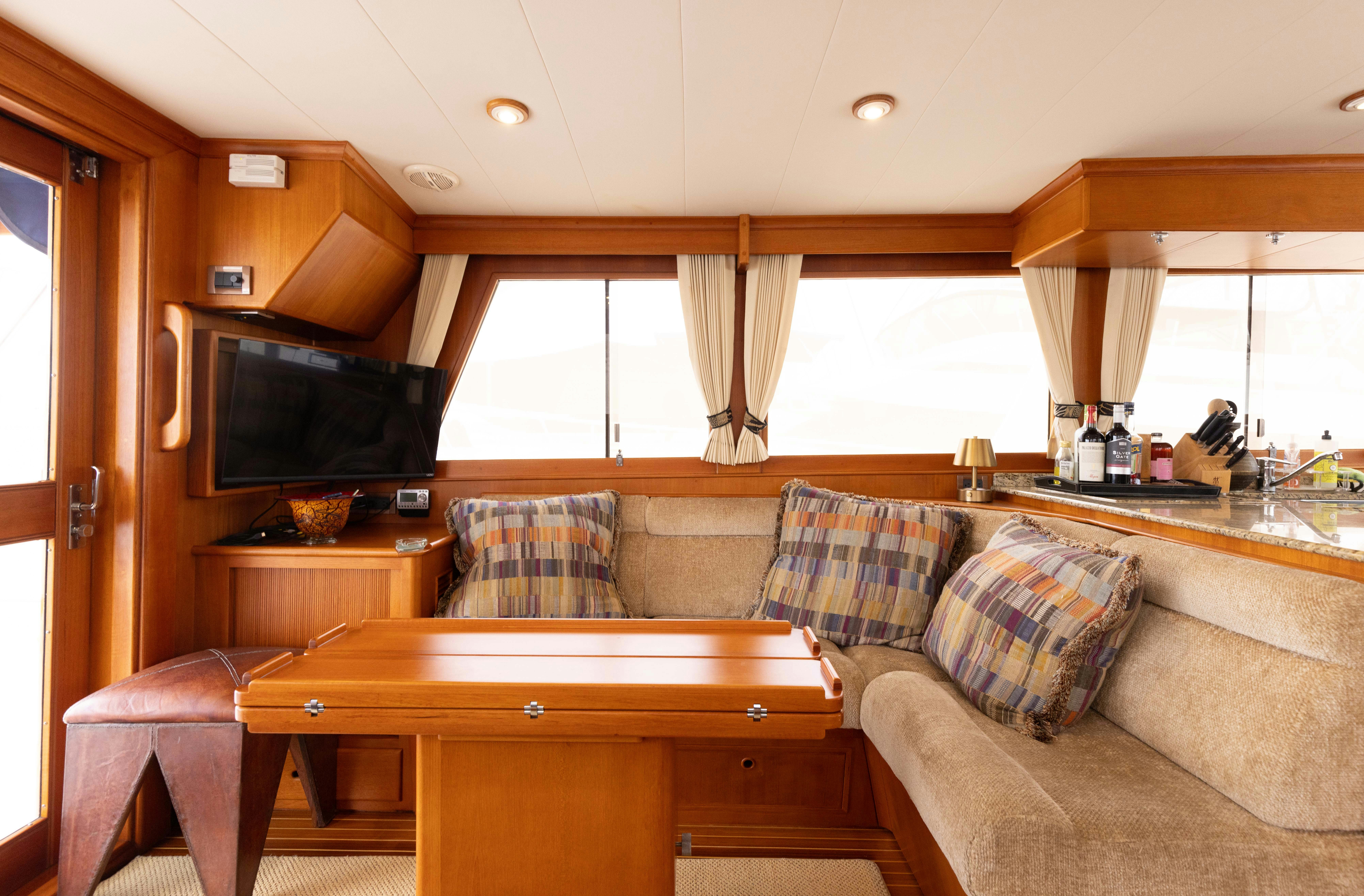 a living room with a couch and a television aboard INDABA Yacht for Sale