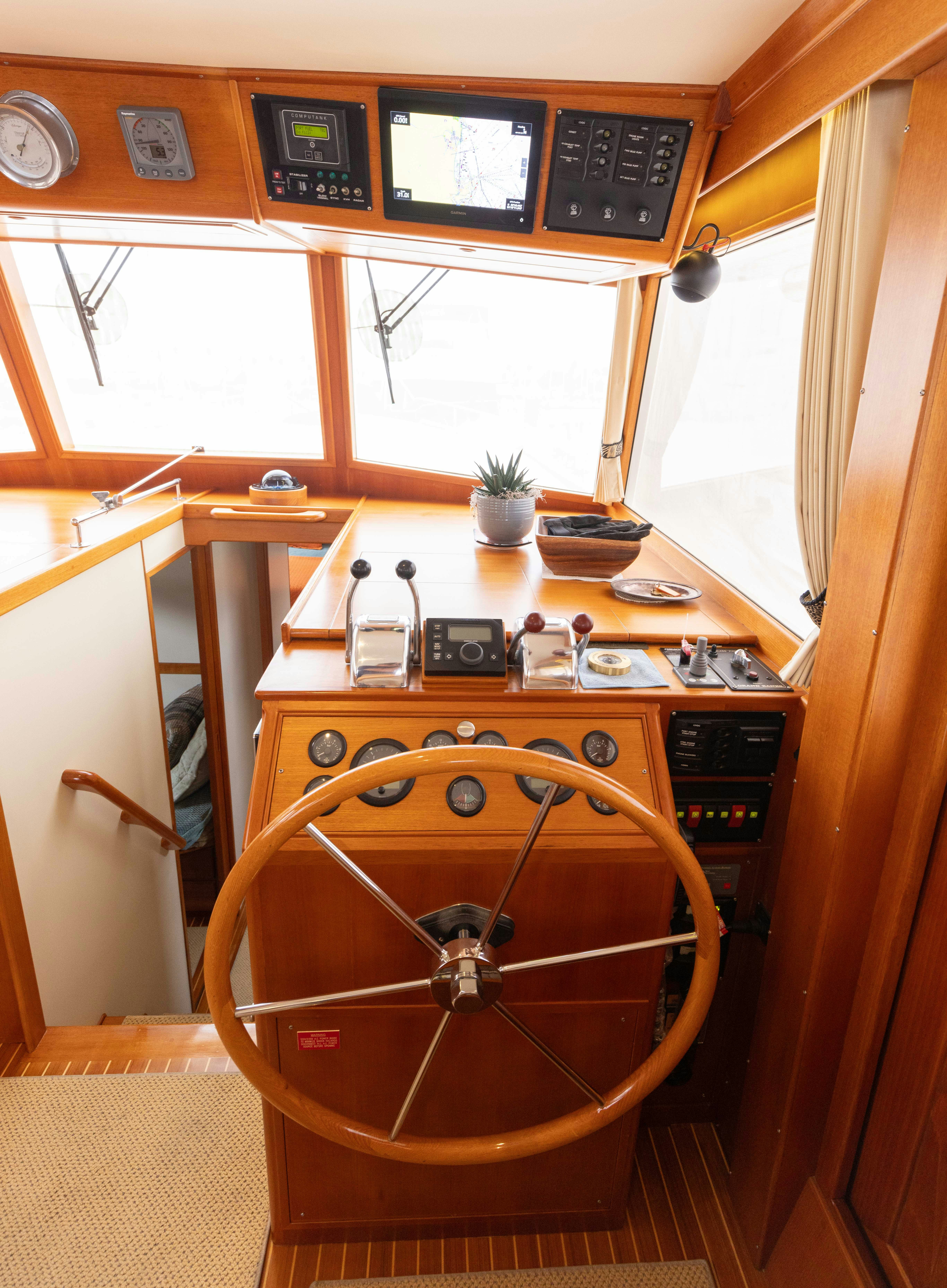 a wooden wheel in a room aboard INDABA Yacht for Sale