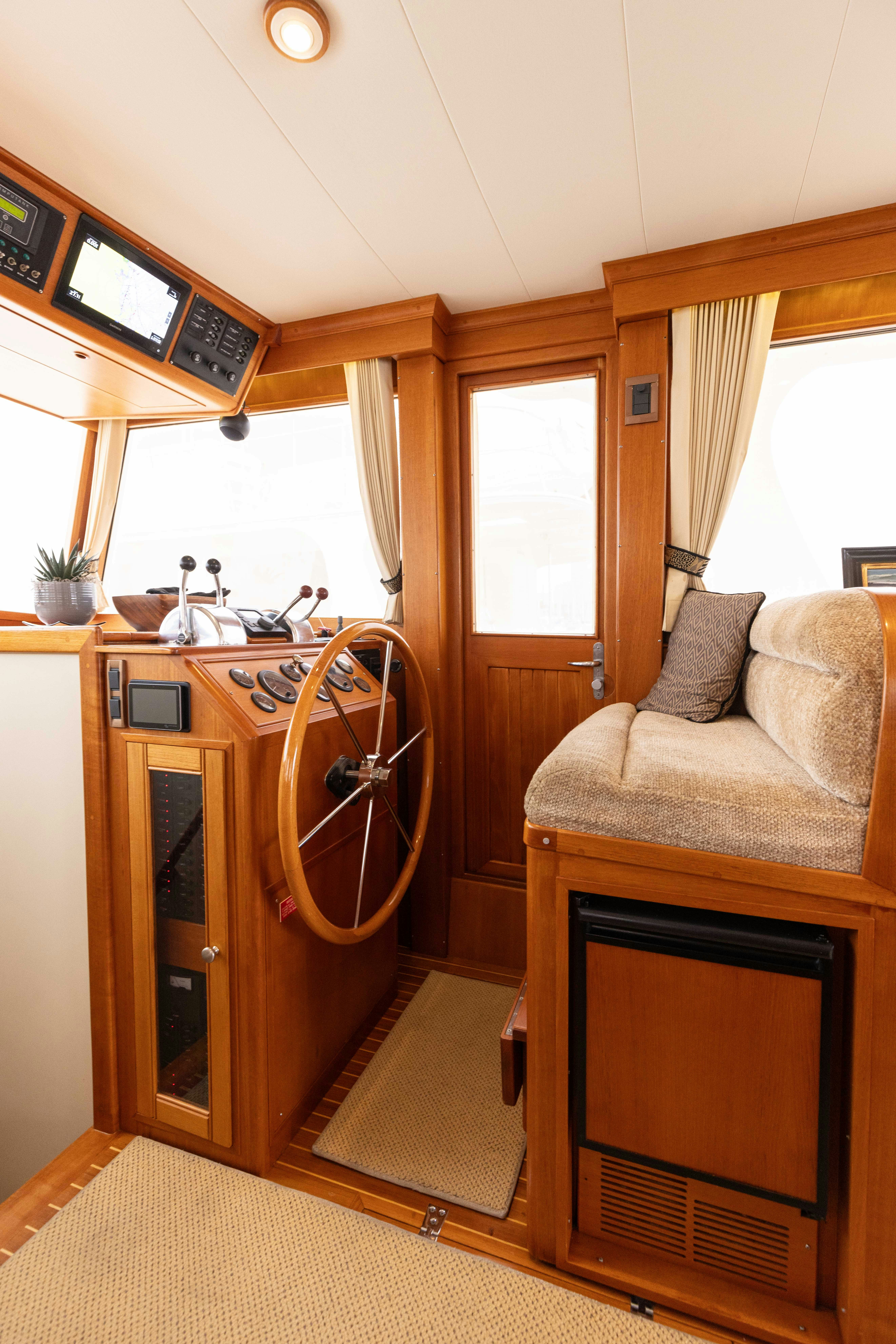 a living room with a couch and a television aboard INDABA Yacht for Sale