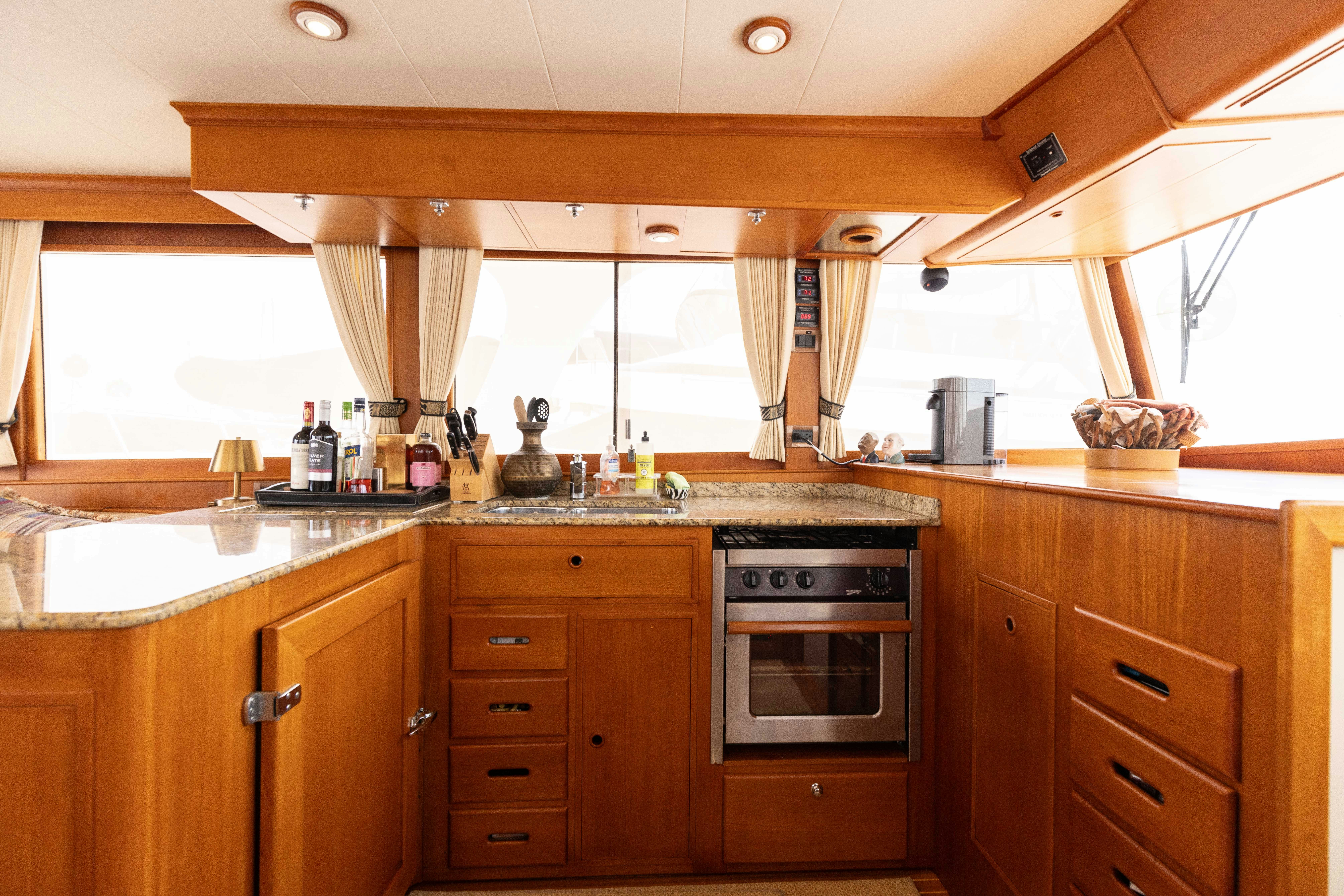 a kitchen with wooden cabinets aboard INDABA Yacht for Sale