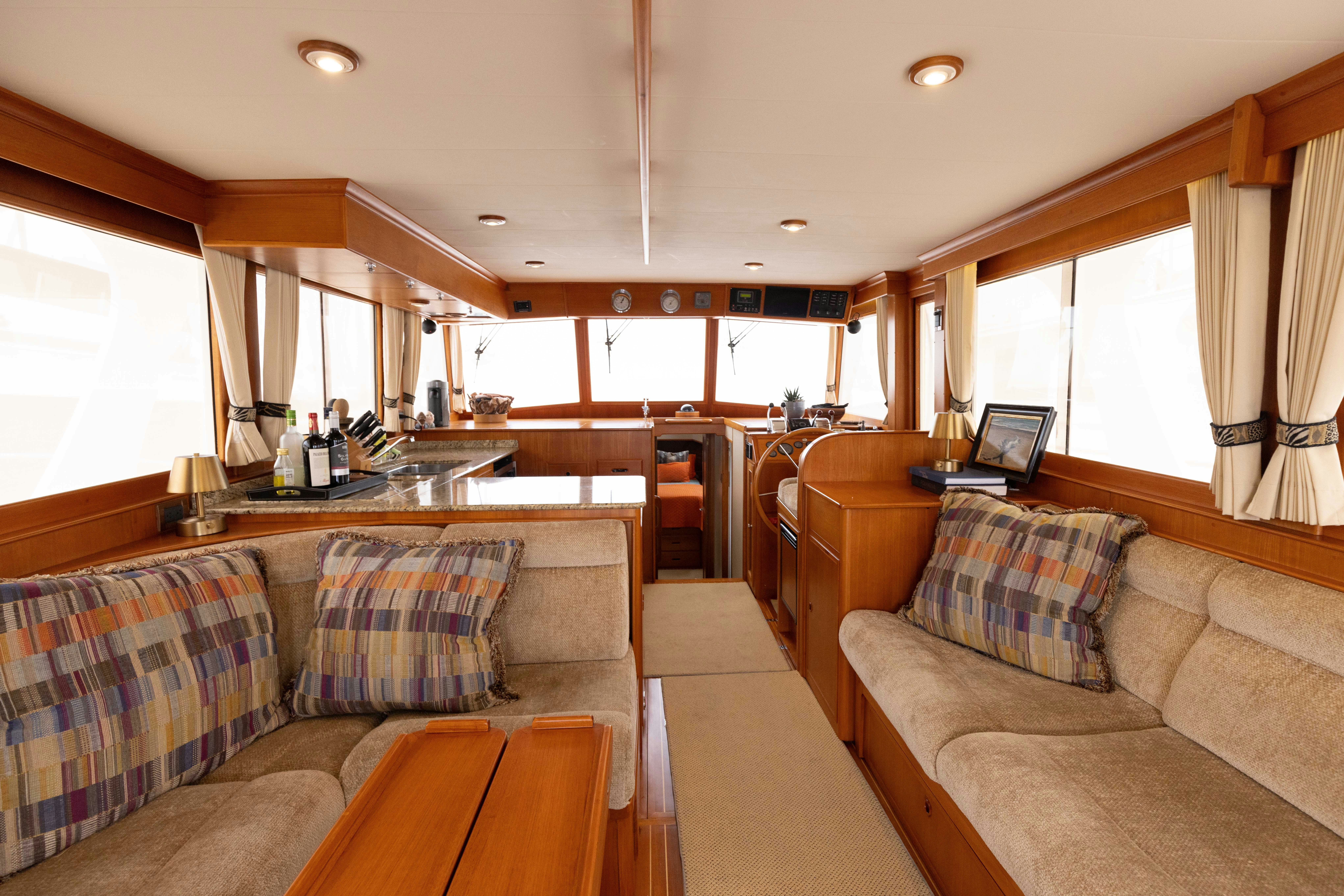 a living room with a couch and a coffee table aboard INDABA Yacht for Sale