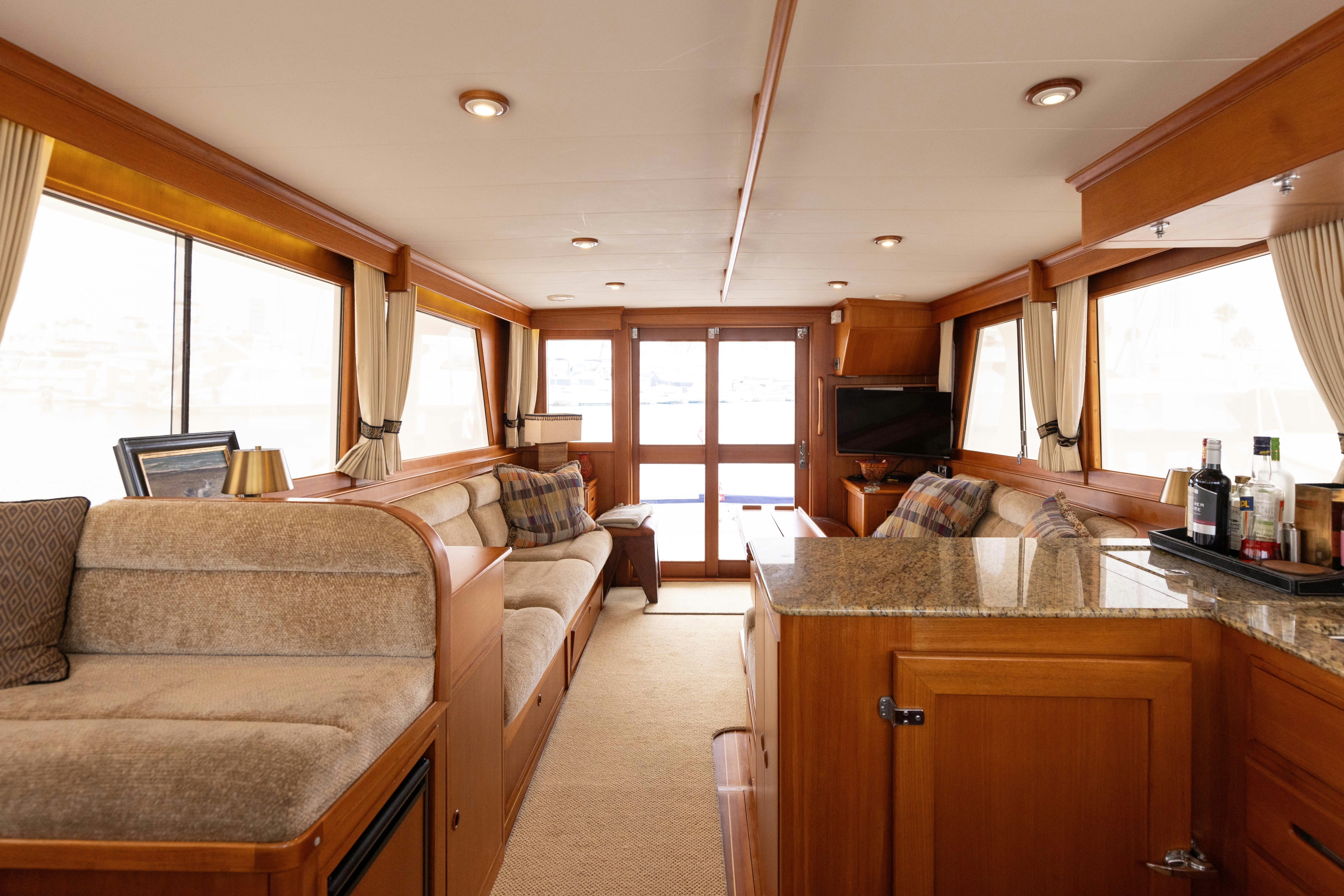 a living room with a couch and a tv aboard INDABA Yacht for Sale