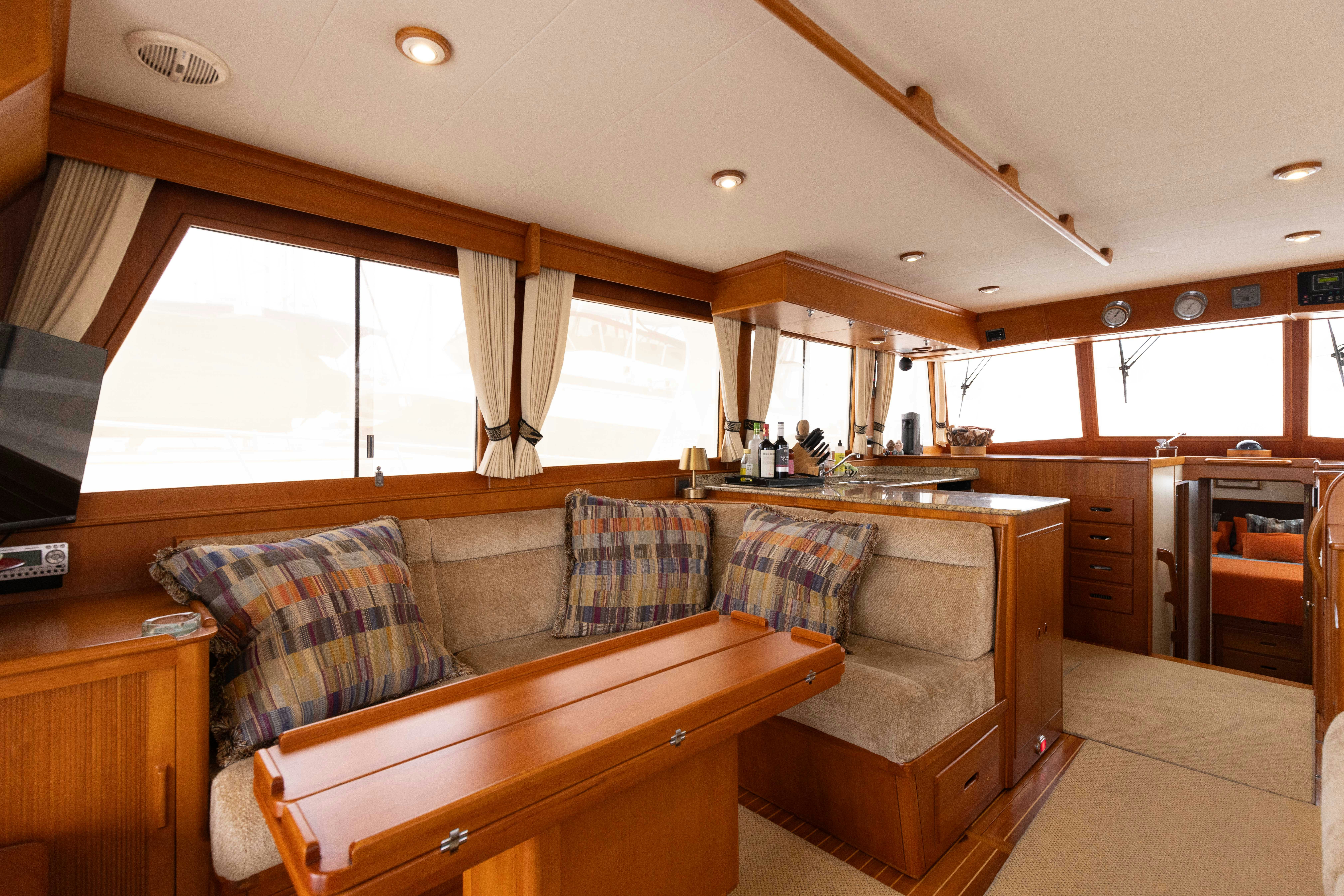 a living room with a couch and a table aboard INDABA Yacht for Sale