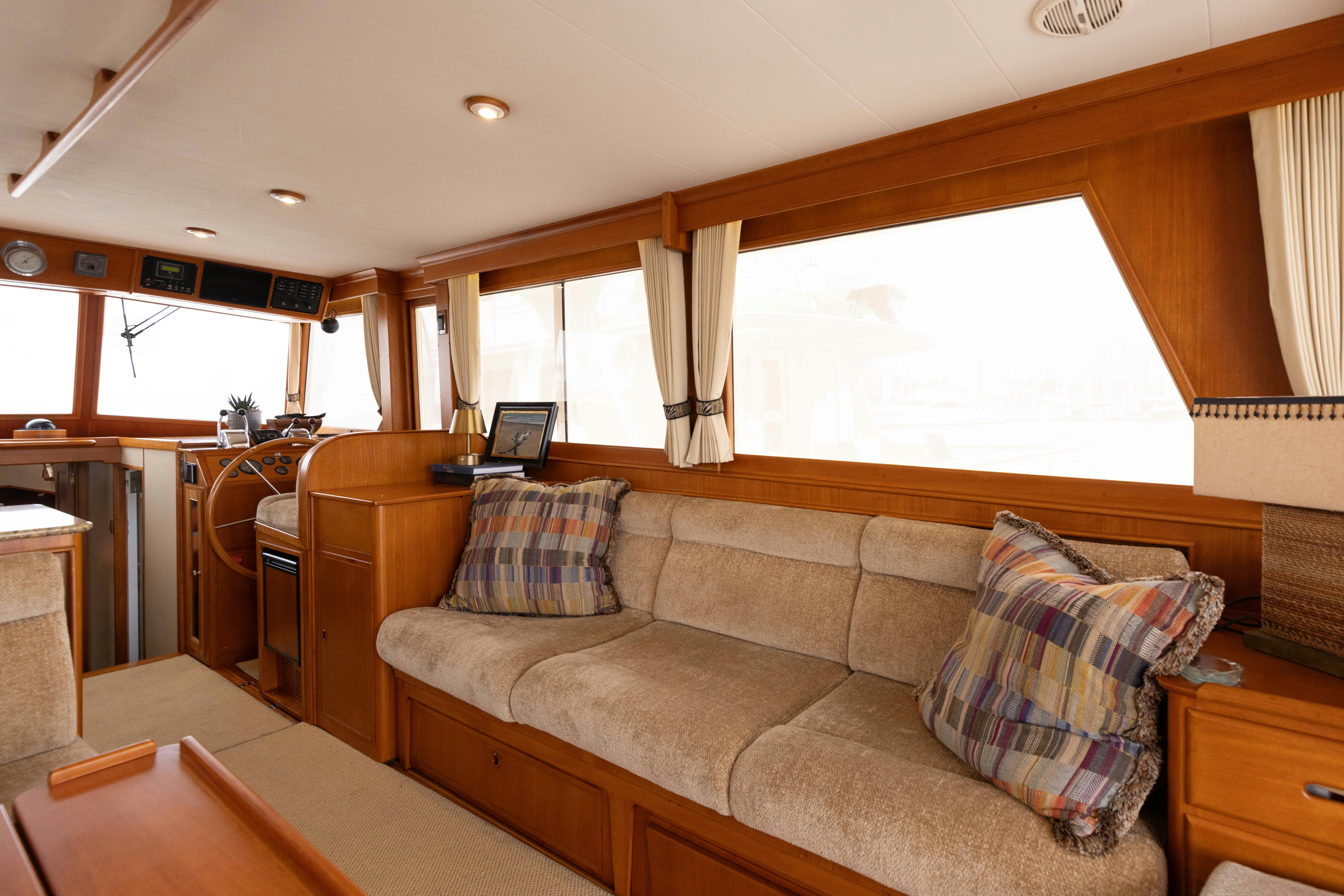 a living room with a couch and a table aboard INDABA Yacht for Sale