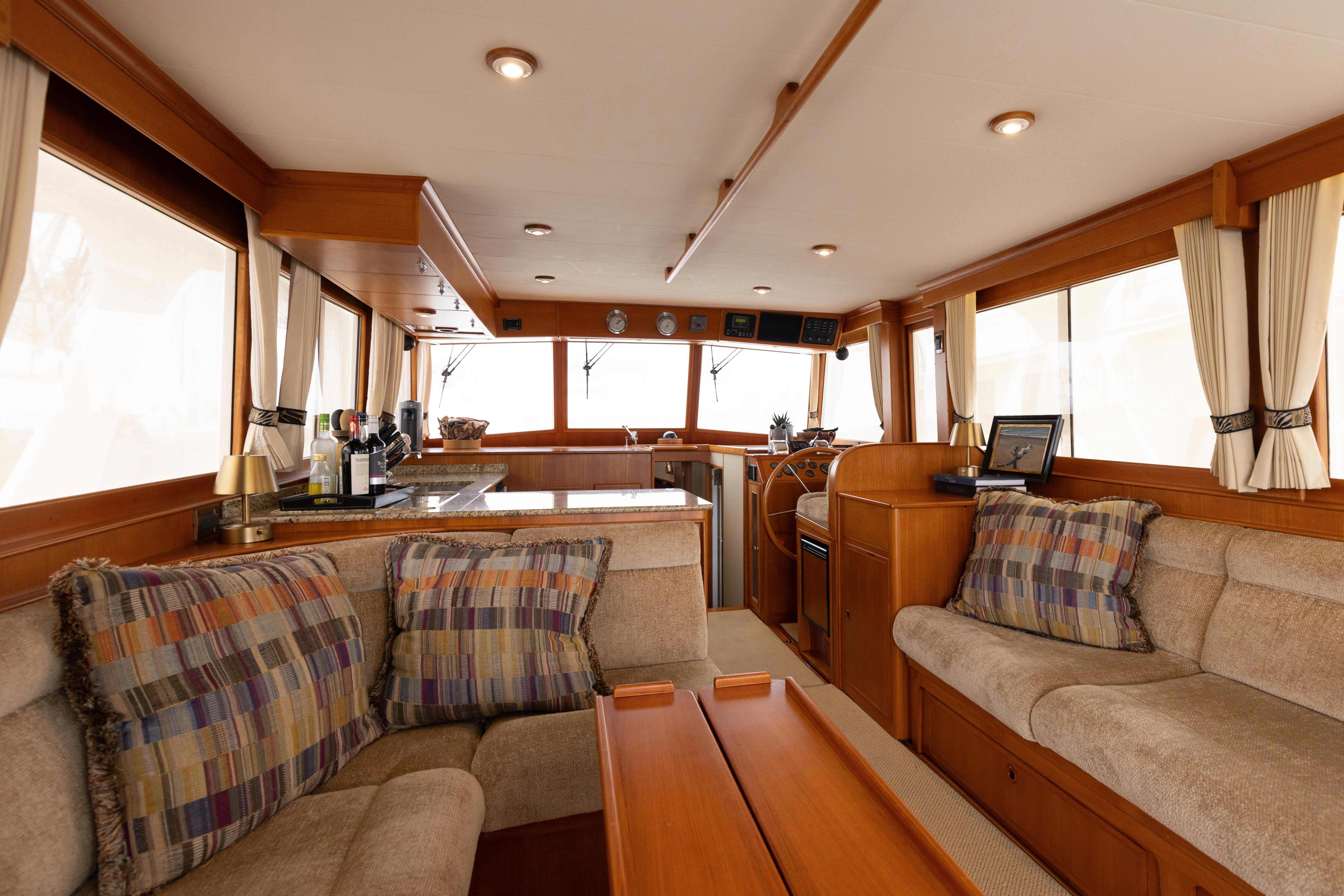 a living room with a couch and a table aboard INDABA Yacht for Sale