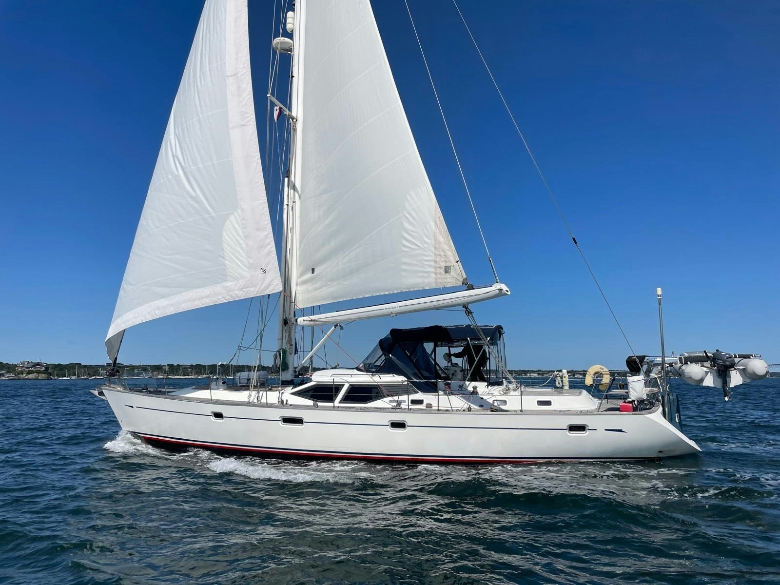 a white boat on the water aboard DREAM AGAIN II Yacht for Sale