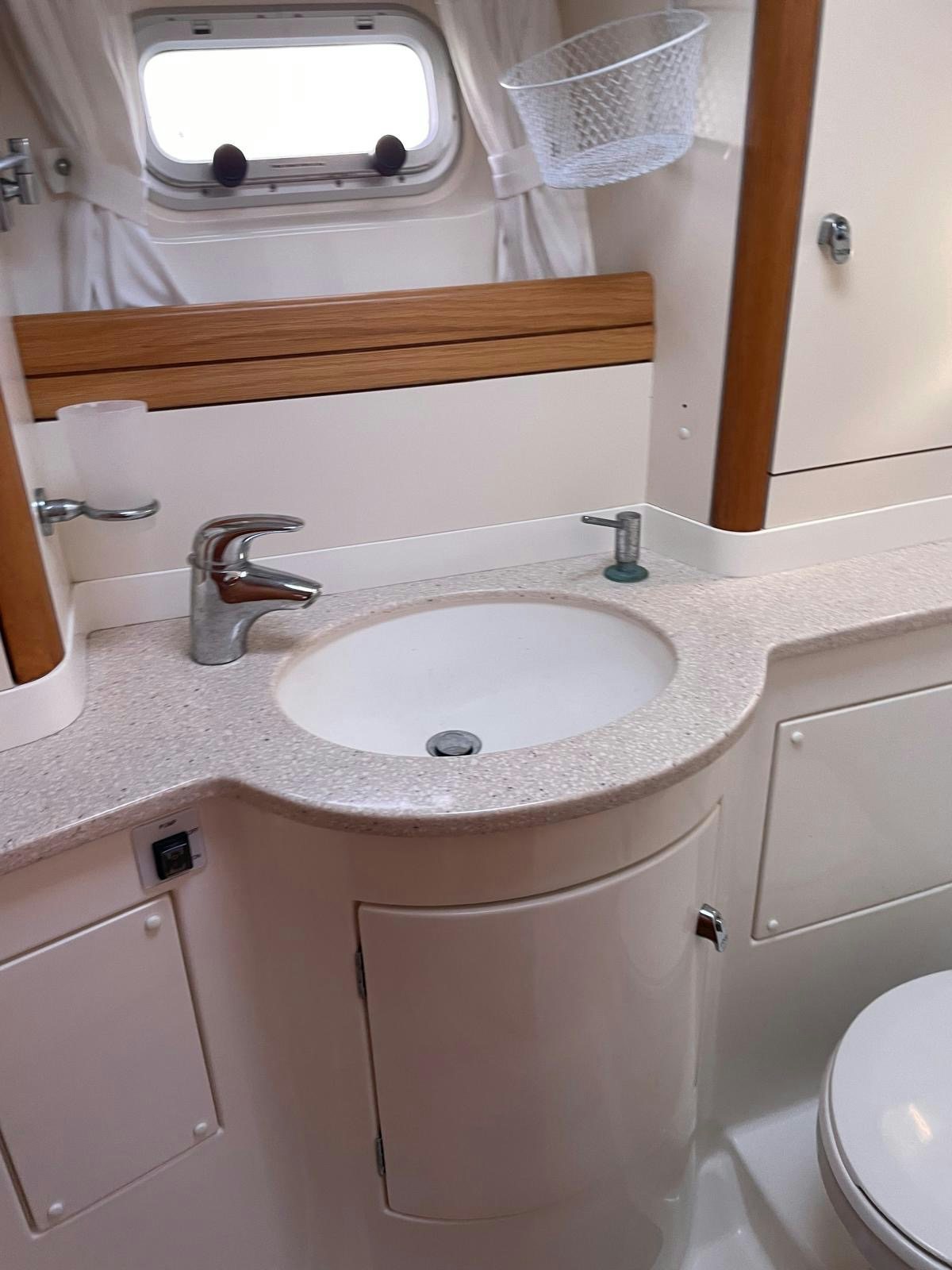 a bathroom with a sink and a mirror aboard DREAM AGAIN II Yacht for Sale