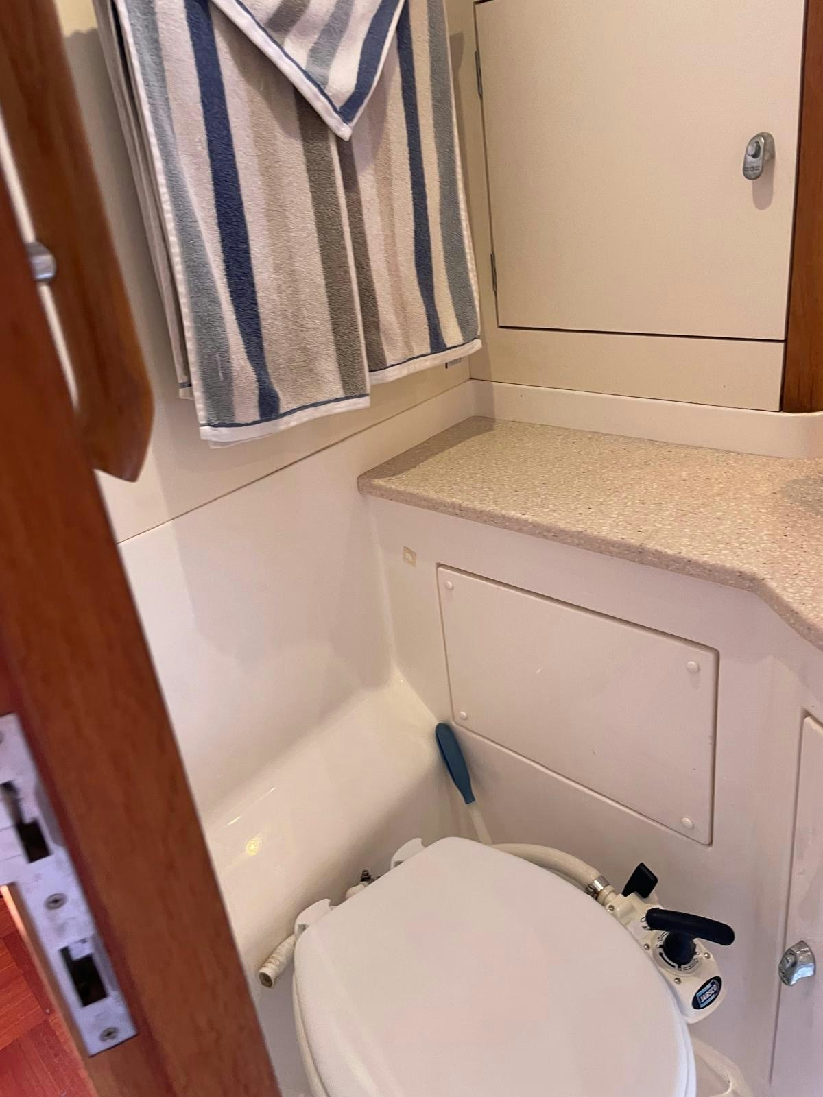 a bathroom with a toilet and a sink aboard DREAM AGAIN II Yacht for Sale