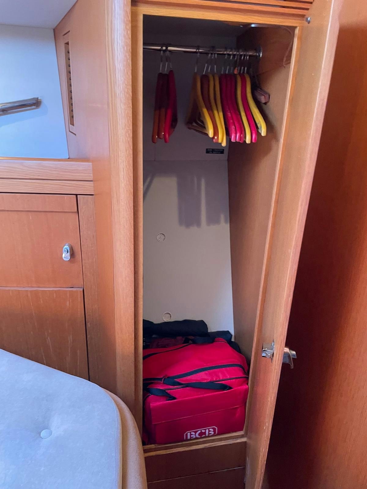 a closet with clothes on the wall aboard DREAM AGAIN II Yacht for Sale