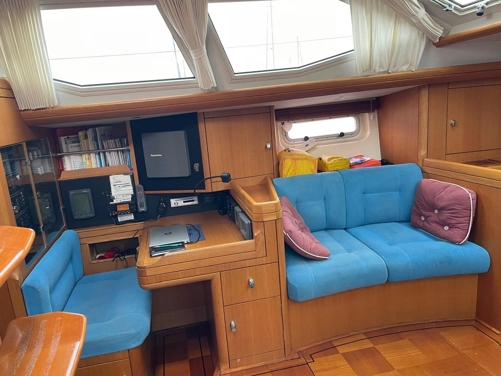 a living room with a blue couch aboard DREAM AGAIN II Yacht for Sale
