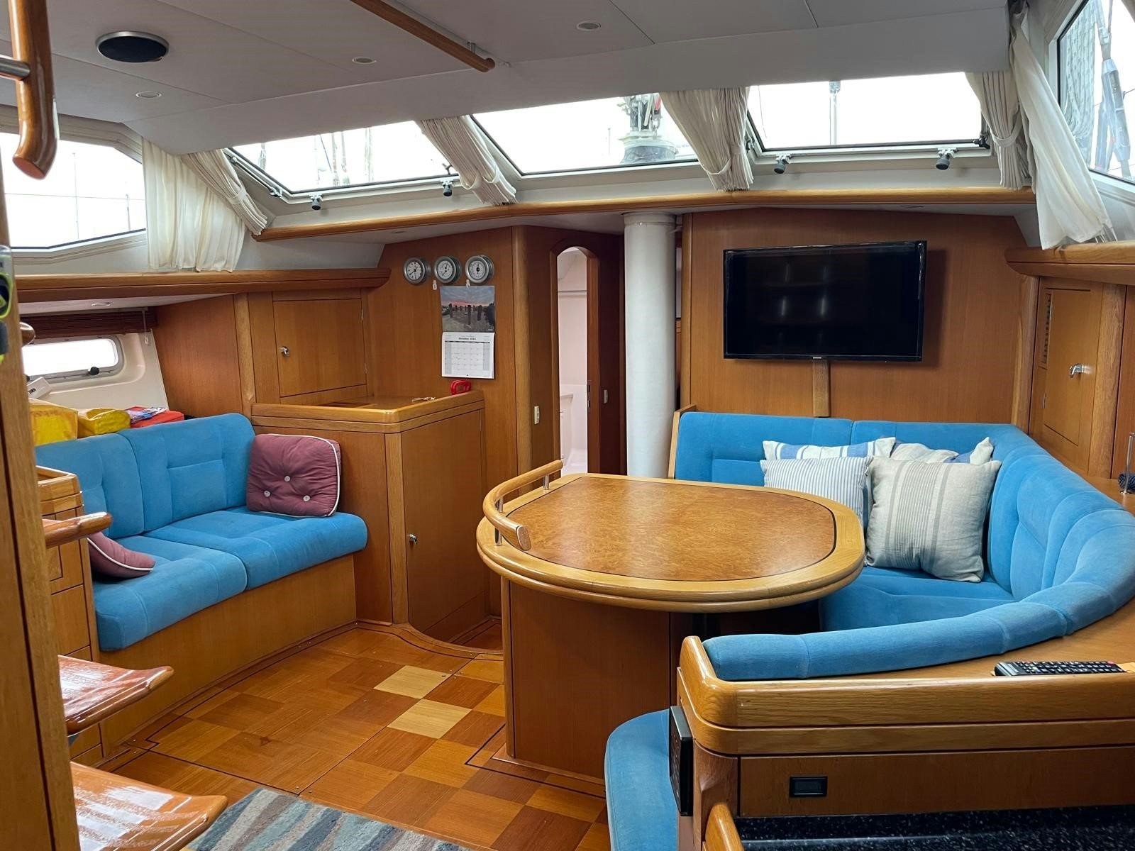 a living room with a couch and a table aboard DREAM AGAIN II Yacht for Sale