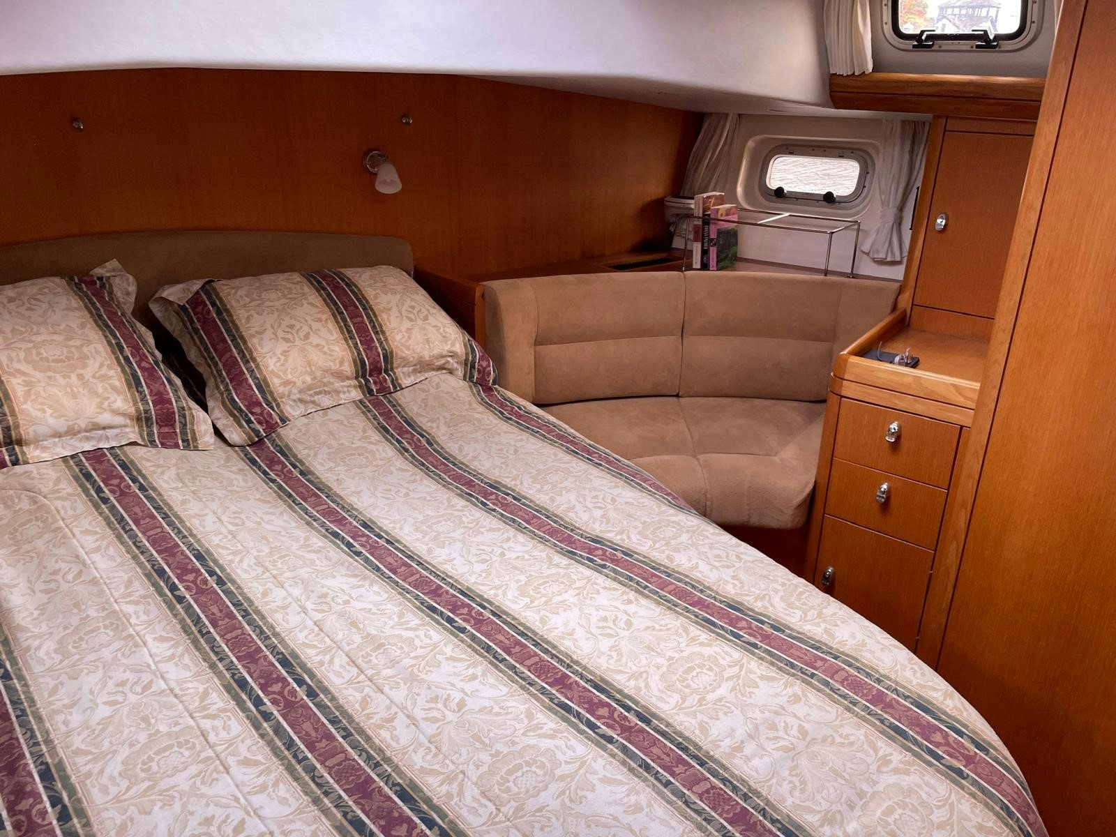 a bed with a colorful comforter aboard DREAM AGAIN II Yacht for Sale