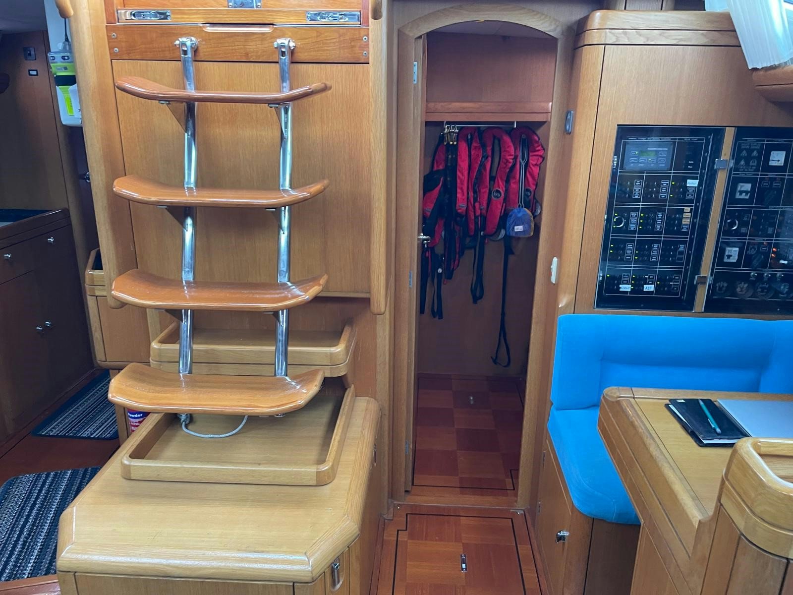 a closet with clothes on the wall aboard DREAM AGAIN II Yacht for Sale