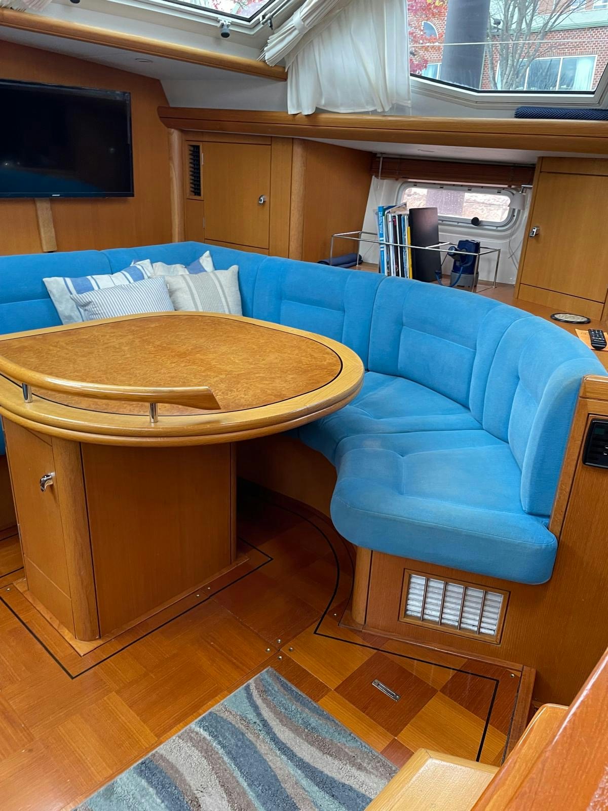 a room with a couch and a table aboard DREAM AGAIN II Yacht for Sale