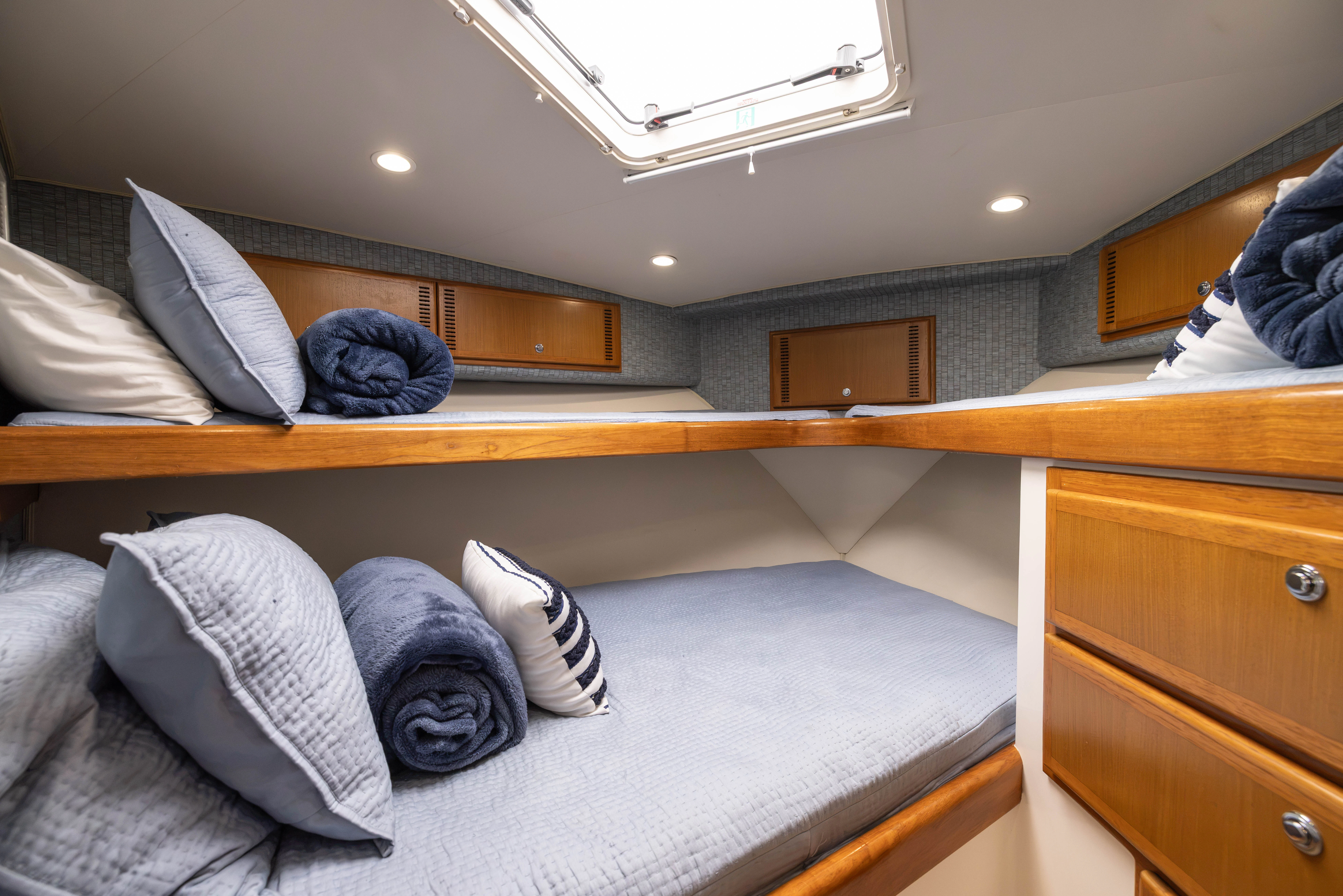 a bed with pillows on it aboard SHOW TIME Yacht for Sale