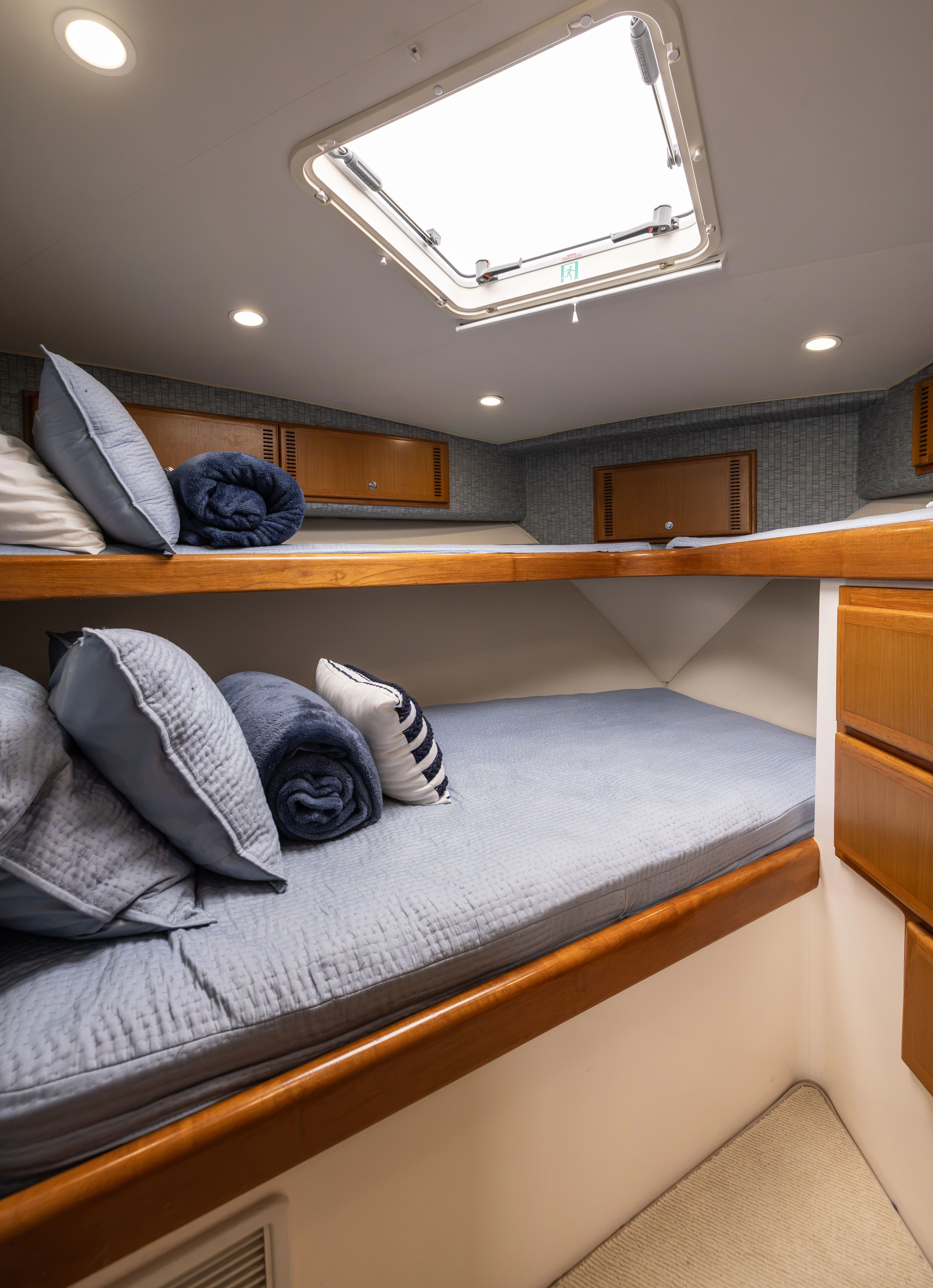 a bed with a blue blanket aboard SHOW TIME Yacht for Sale