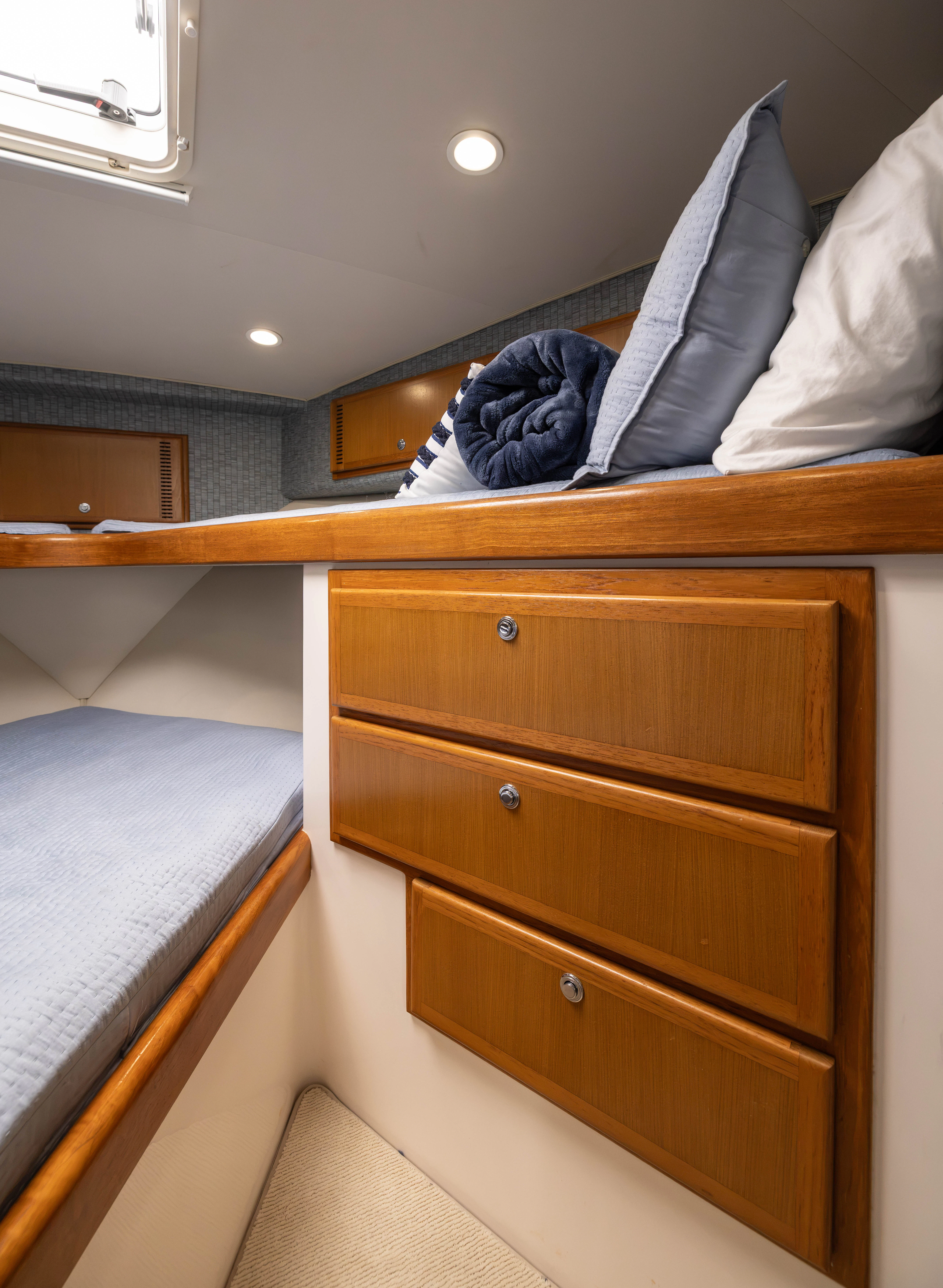 a bed with a wooden headboard aboard SHOW TIME Yacht for Sale