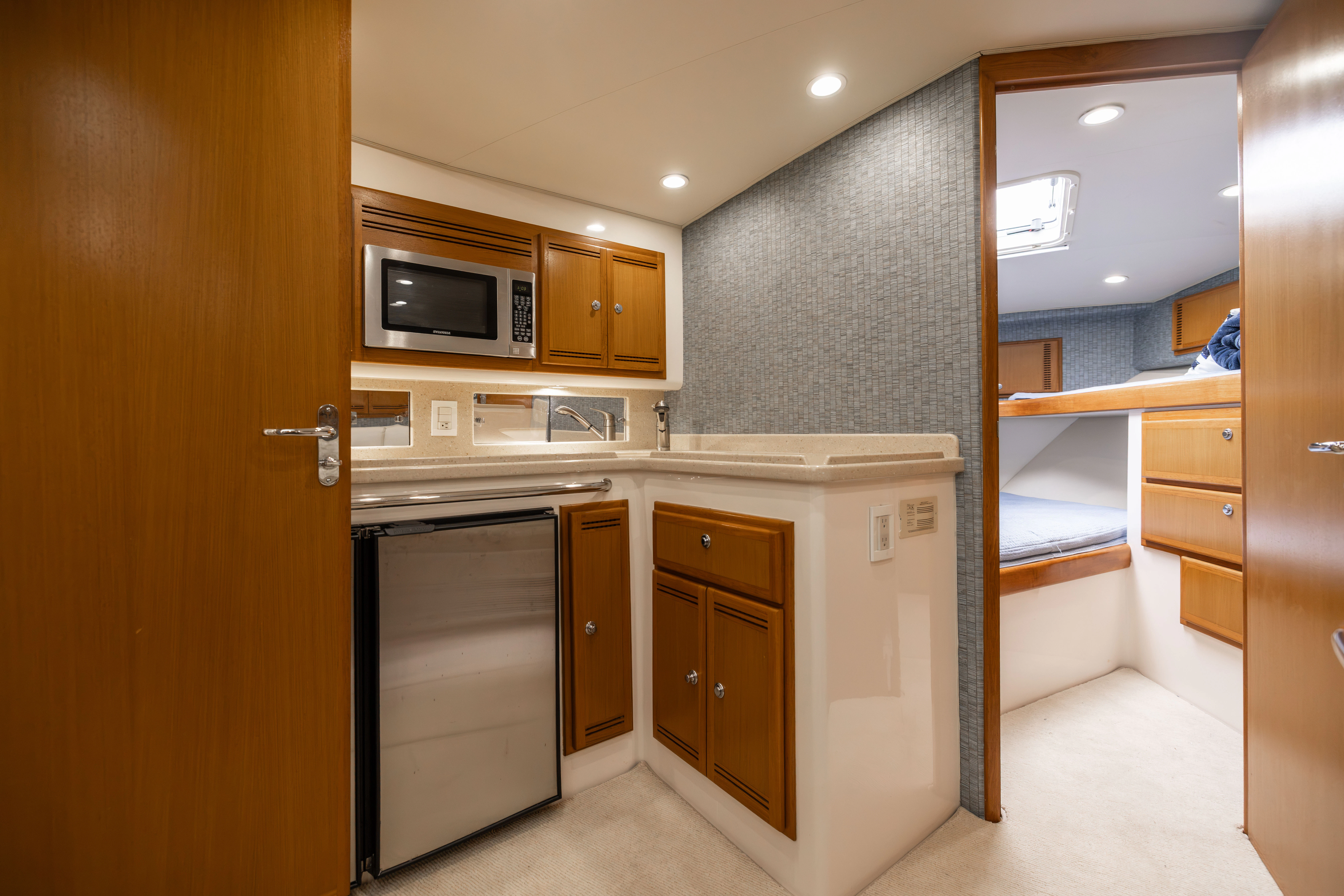 a kitchen with a microwave oven and cabinets aboard SHOW TIME Yacht for Sale
