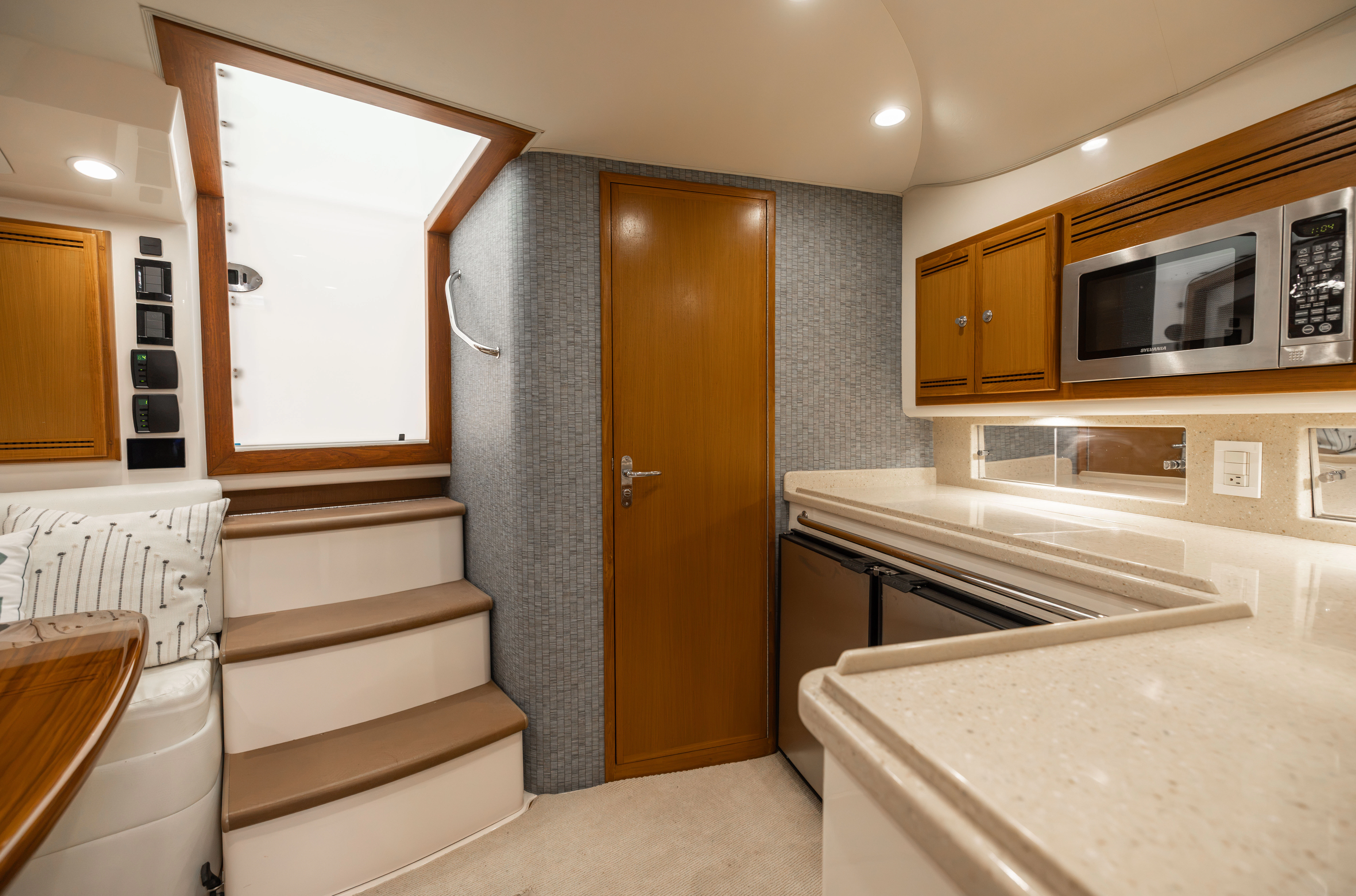 a kitchen with a microwave oven and a refrigerator aboard SHOW TIME Yacht for Sale