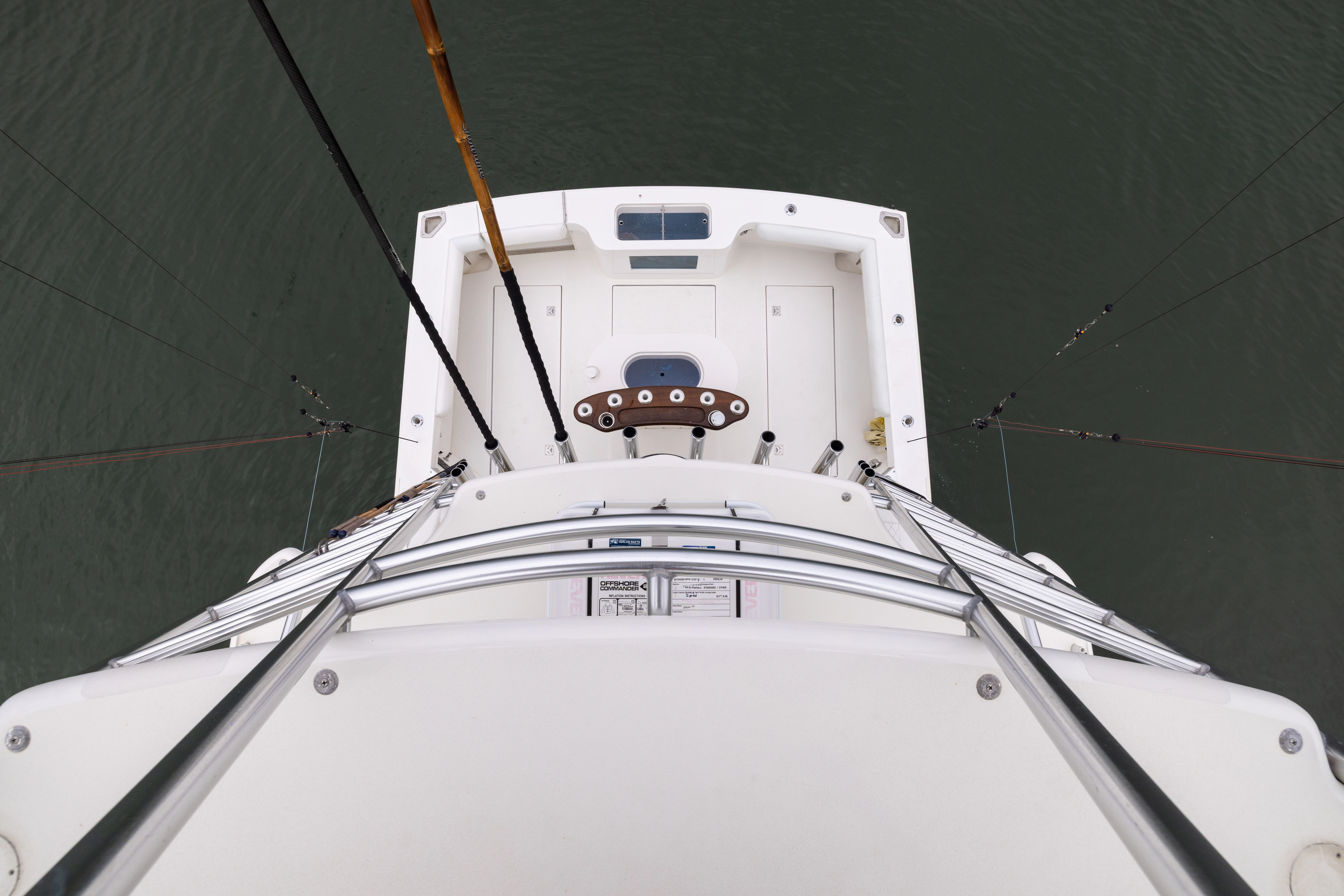 a white boat with a person standing on it aboard SHOW TIME Yacht for Sale