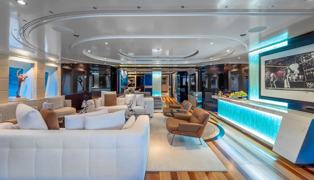 a large room with a large sofa and a large window aboard SCOTT FREE Yacht for Charter