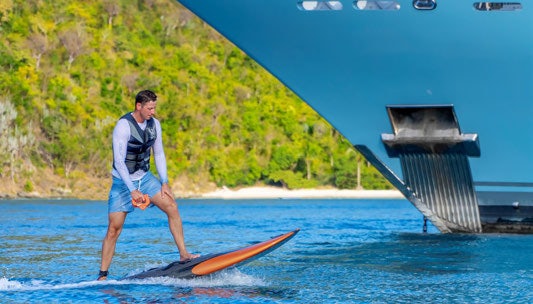 a person is surfing in the sea aboard SCOTT FREE Yacht for Charter