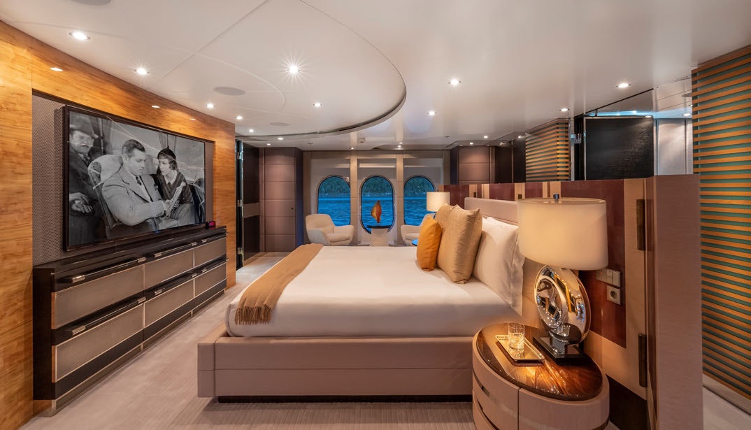 a bedroom with a large television aboard SCOTT FREE Yacht for Charter