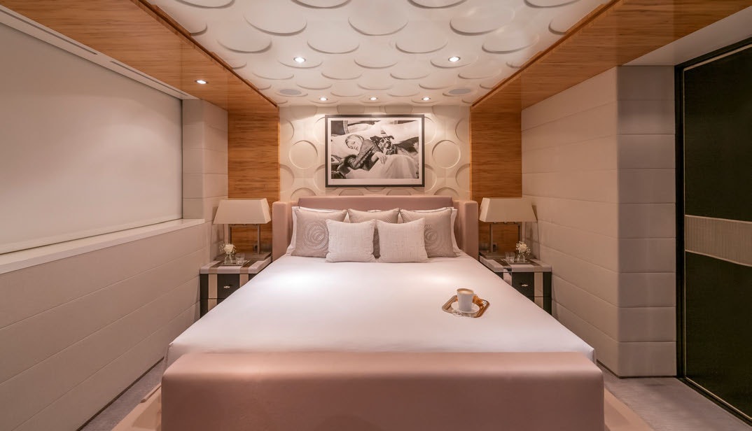 a bed with a white bed spread aboard SCOTT FREE Yacht for Charter
