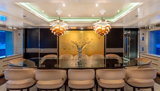 a large room with a chandelier and chairs aboard SCOTT FREE Yacht for Charter