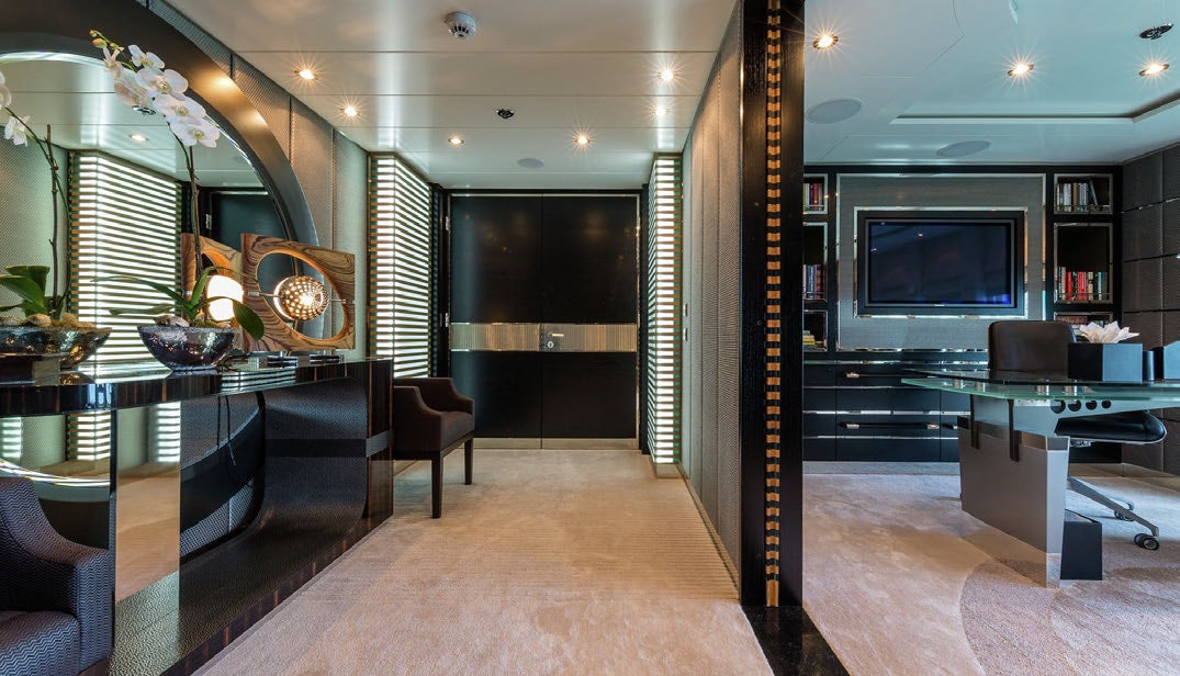 a room with a tv and a table aboard SCOTT FREE Yacht for Charter
