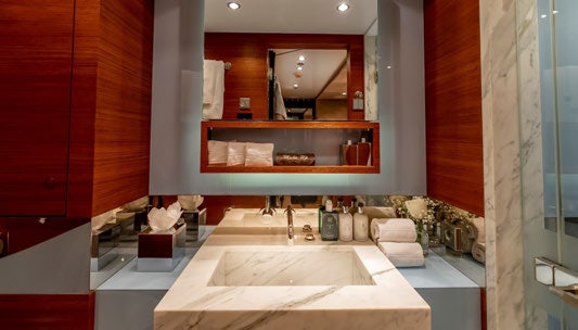 a bathroom with a large mirror aboard SCOTT FREE Yacht for Charter