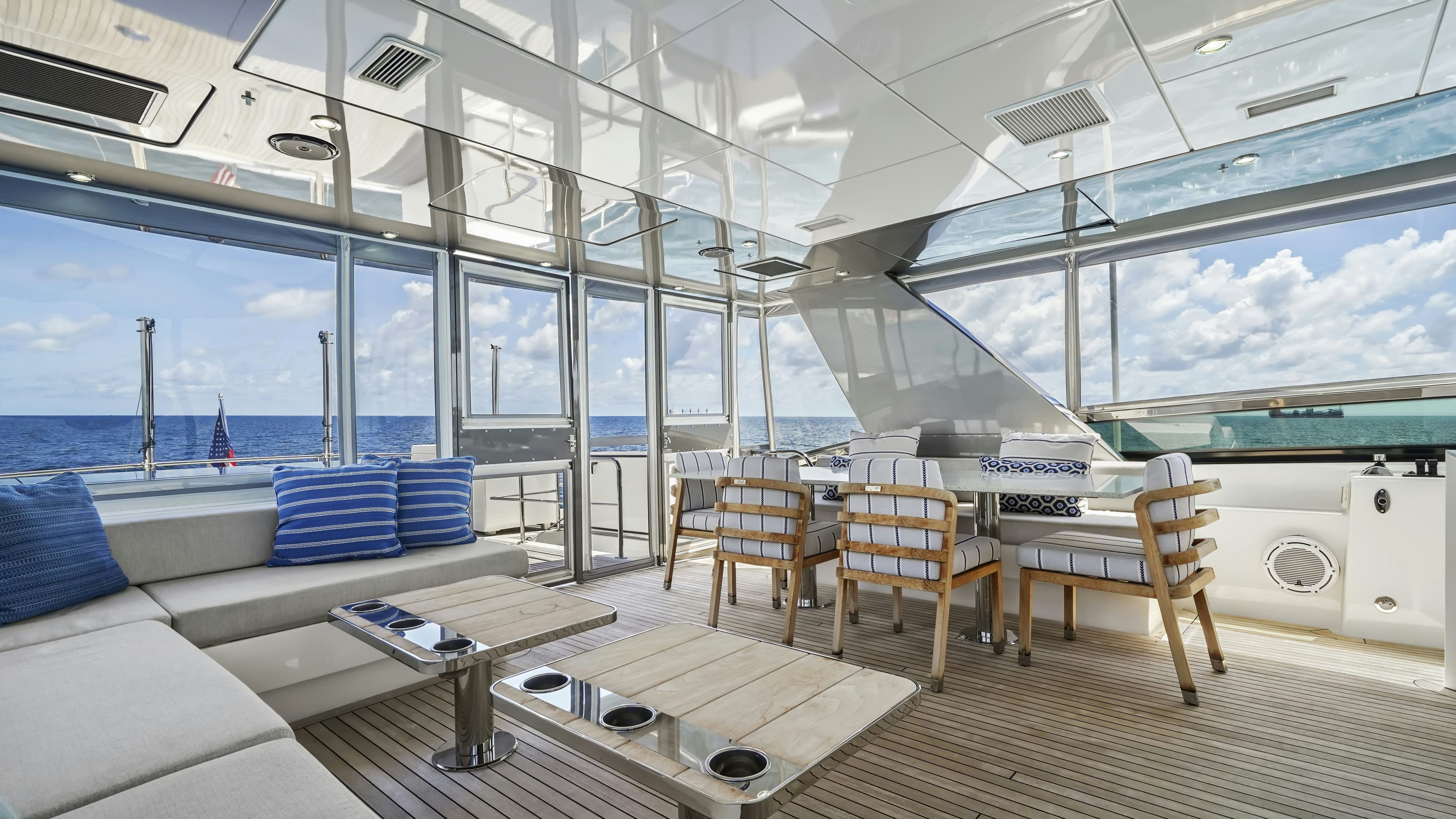 inside of a building with a large window and a table and chairs aboard SURPLUS LINES Yacht for Sale