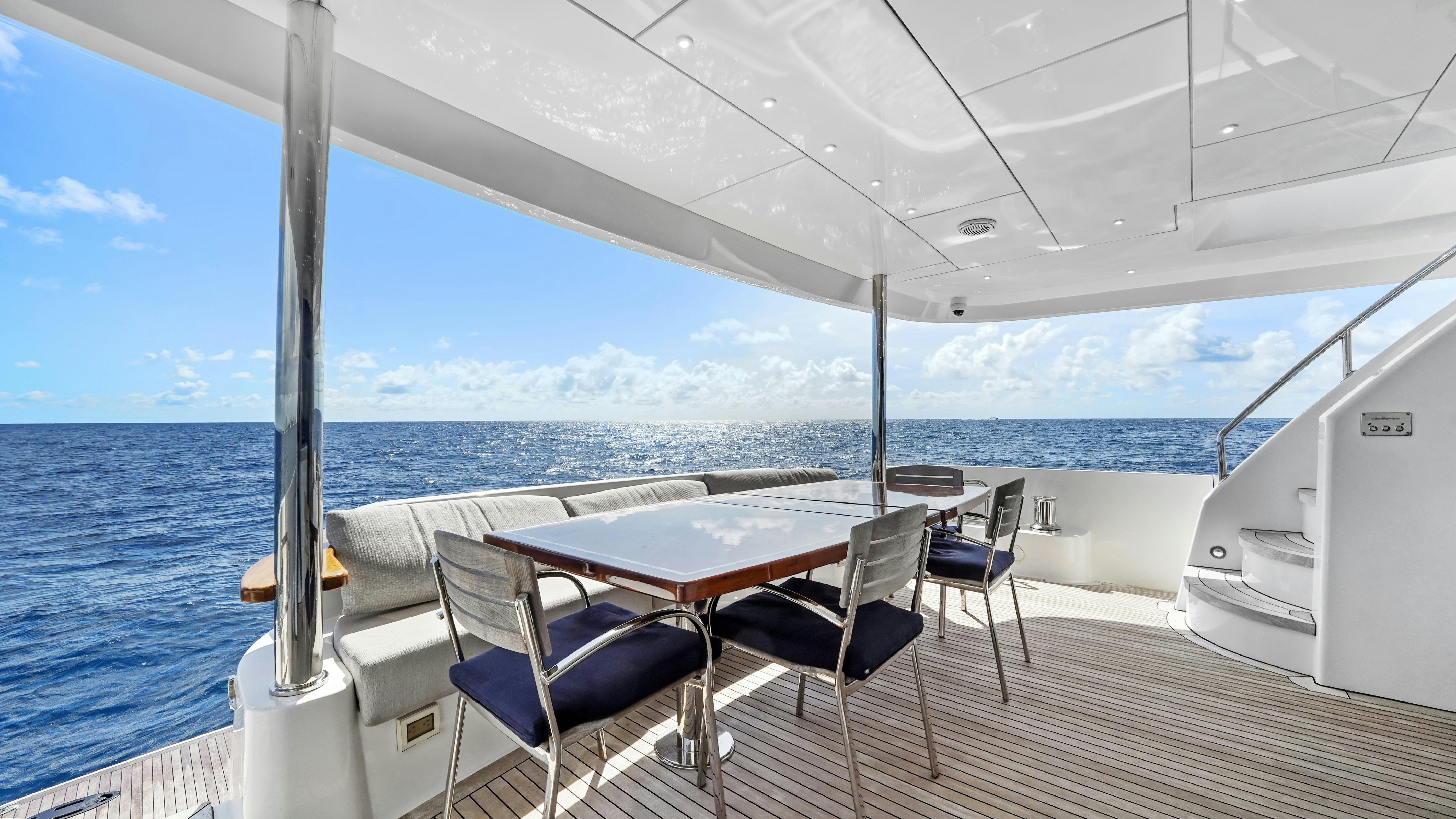 a table and chairs on a boat aboard SURPLUS LINES Yacht for Sale