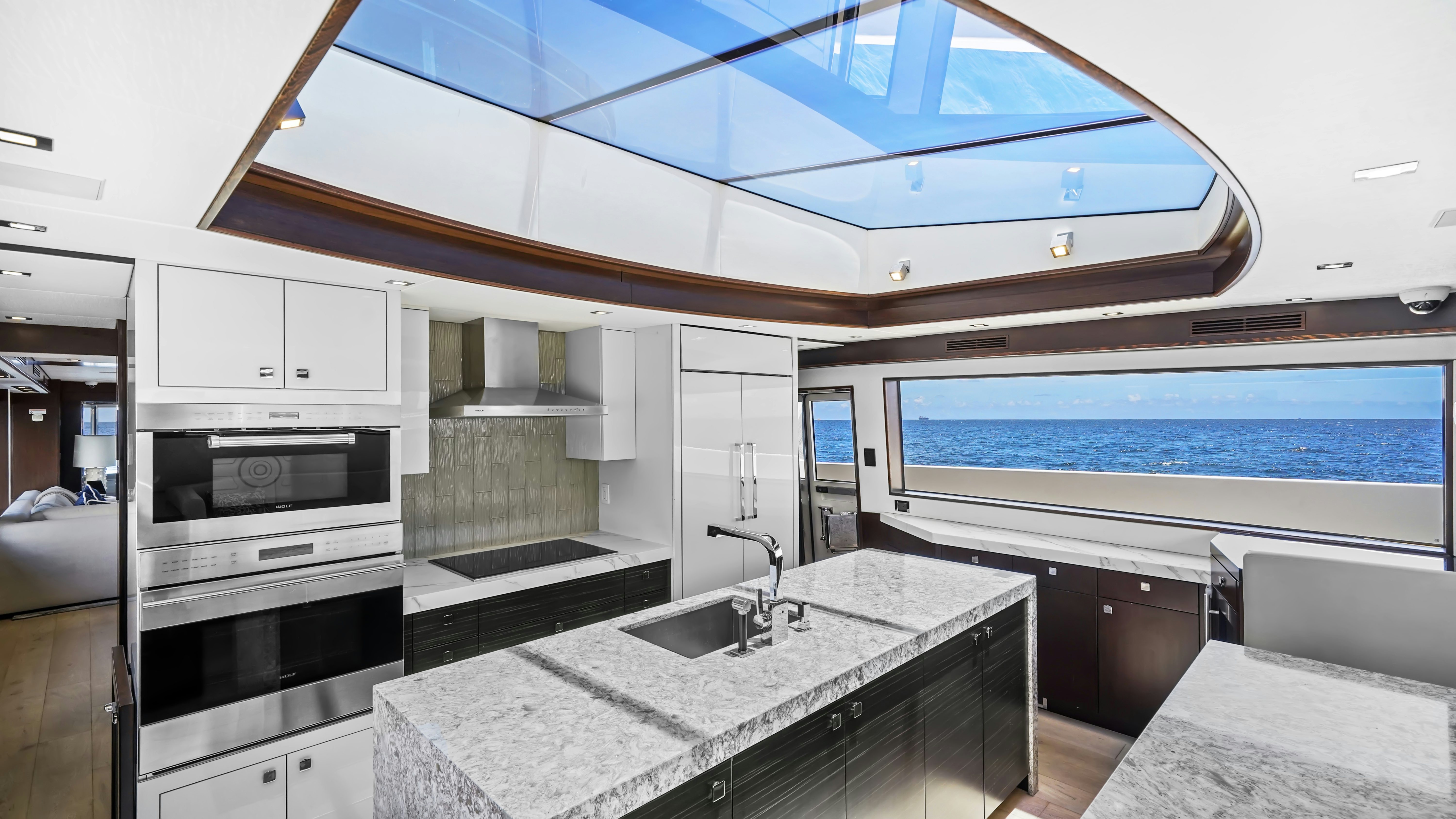 a large kitchen with a large window aboard SURPLUS LINES Yacht for Sale