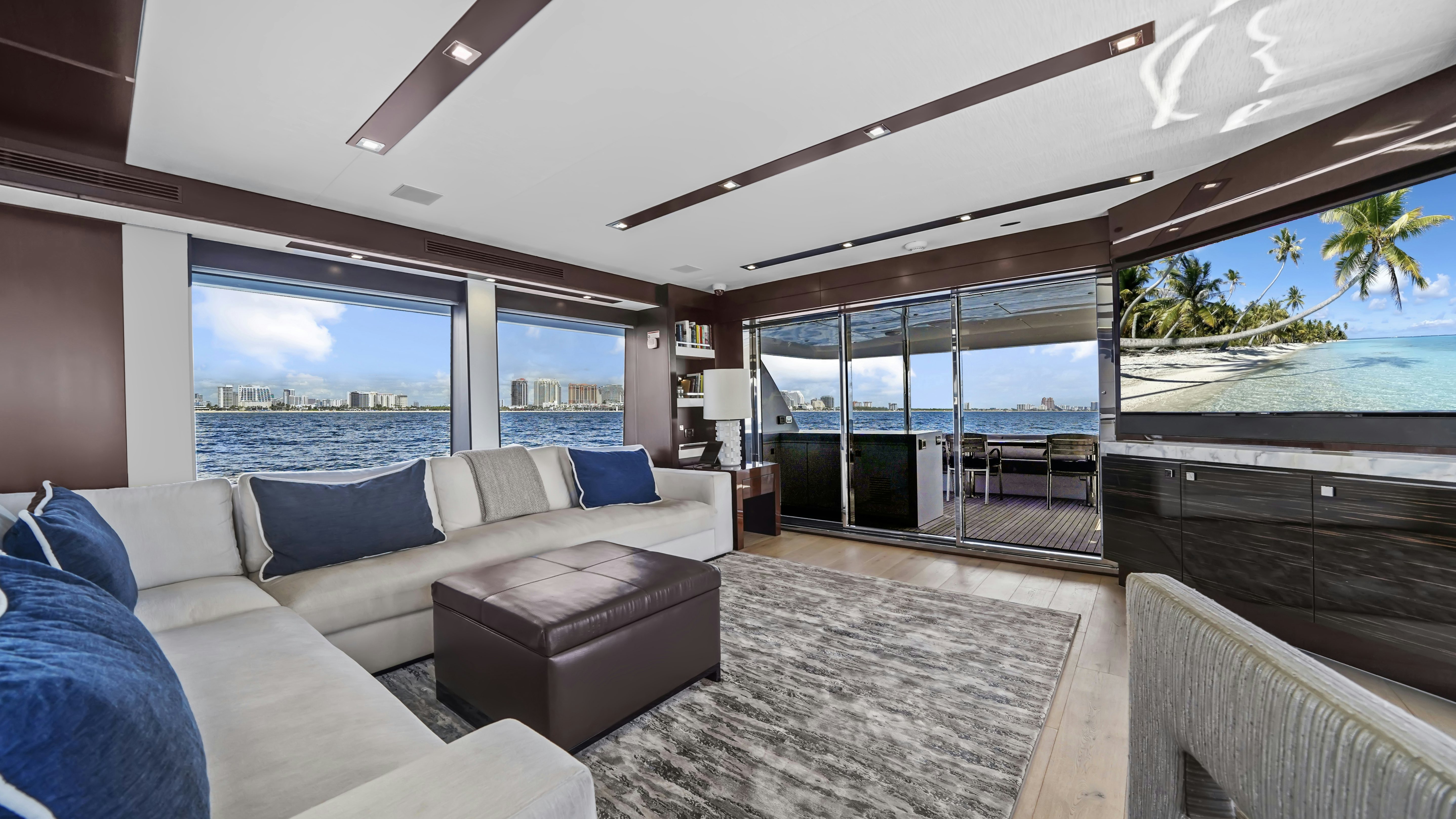 a living room with a large glass door and a large window aboard SURPLUS LINES Yacht for Sale