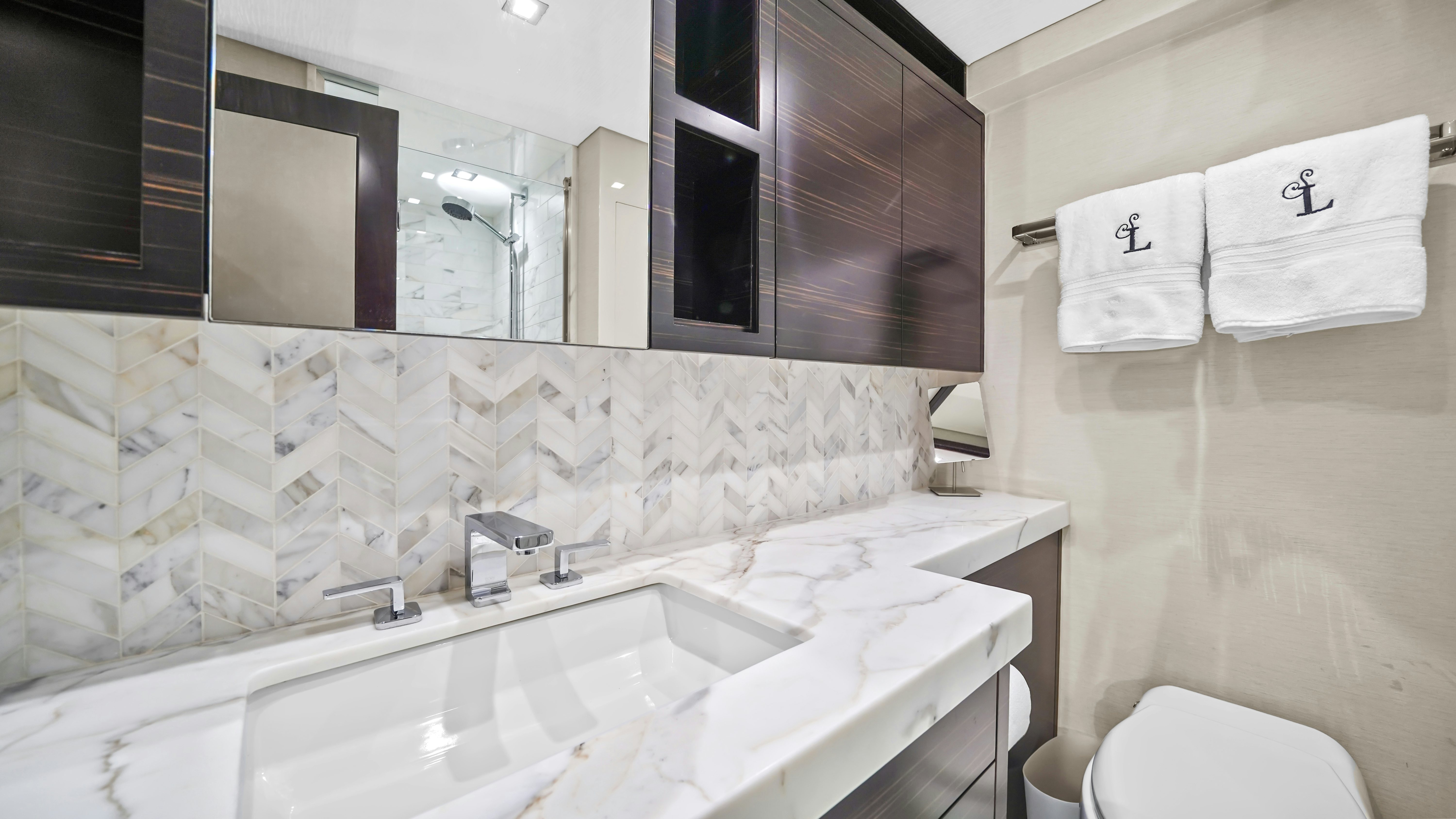 a bathroom with a sink and a toilet aboard SURPLUS LINES Yacht for Sale