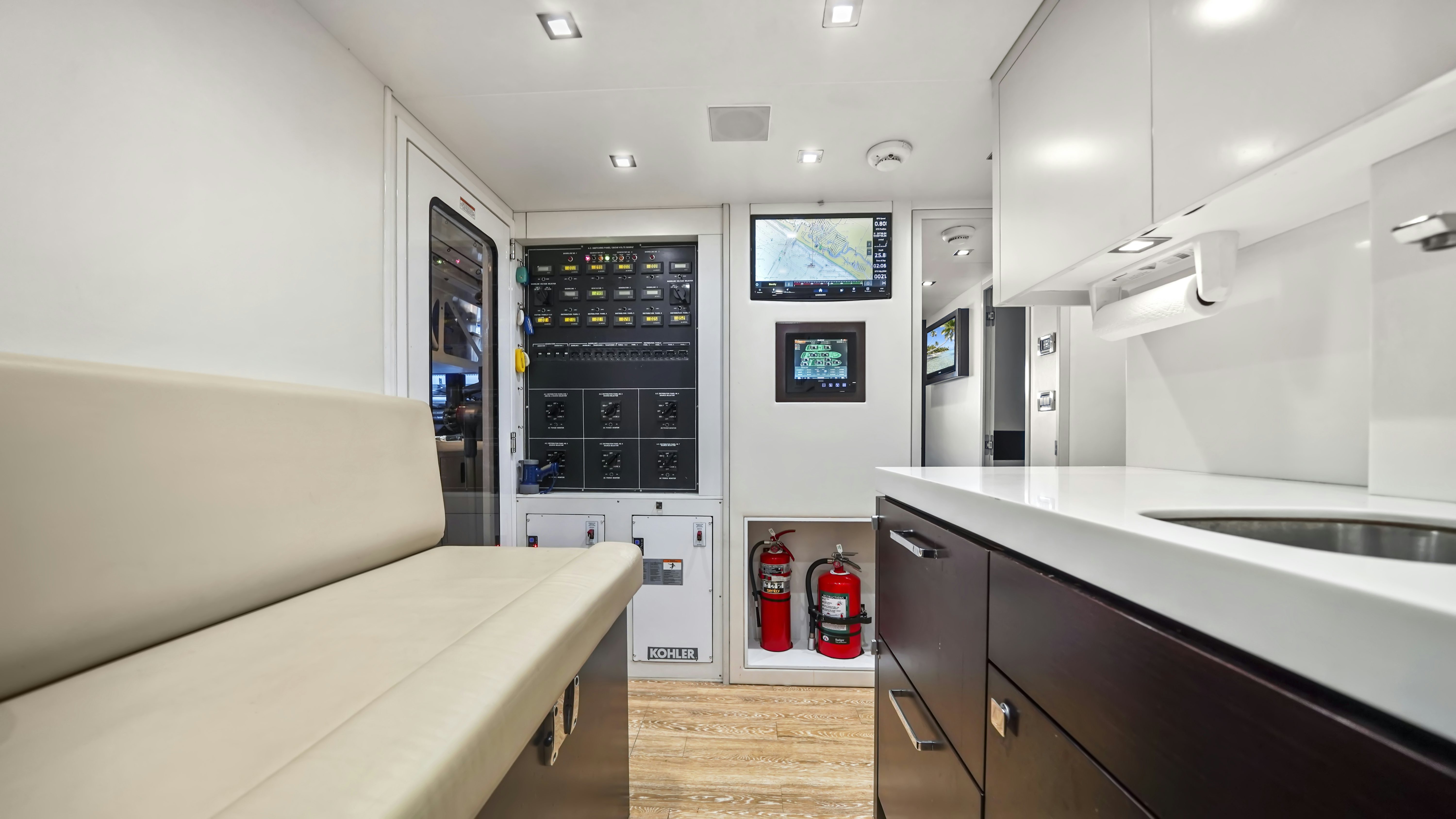 a kitchen with a fridge and a table aboard SURPLUS LINES Yacht for Sale