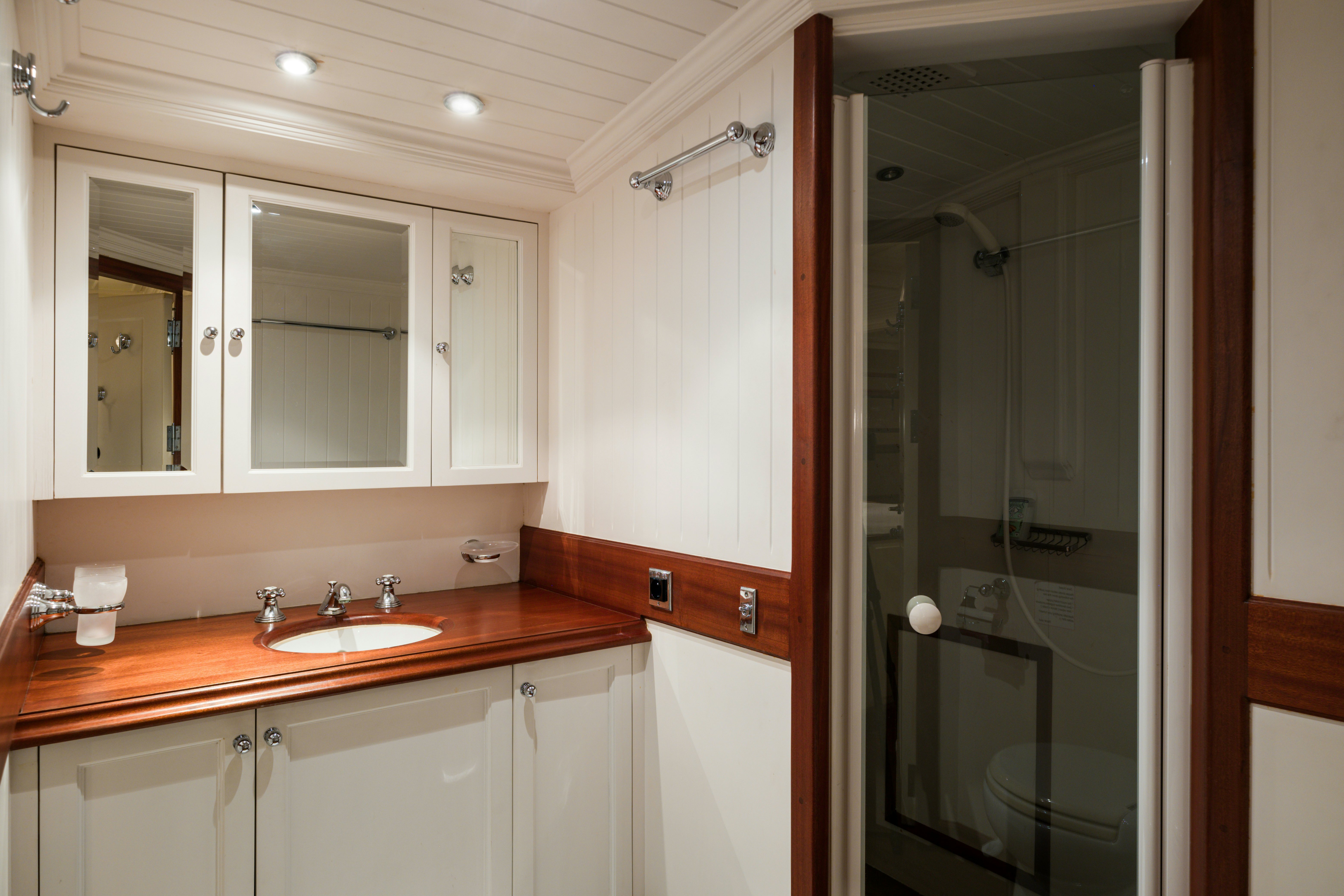 a bathroom with a shower unit and sink aboard STRANGERS IN THE NIGHT Yacht for Sale