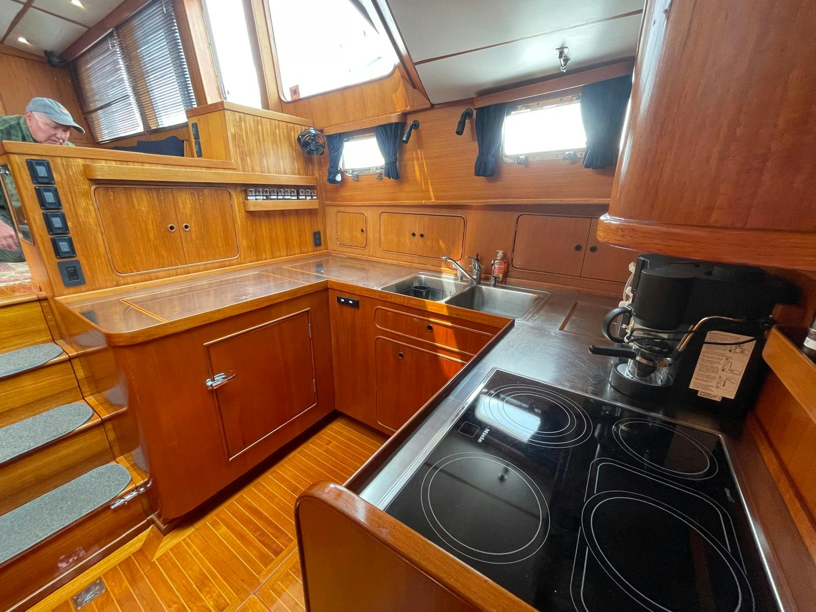 a kitchen with wooden cabinets aboard SOUTHERLY Yacht for Sale