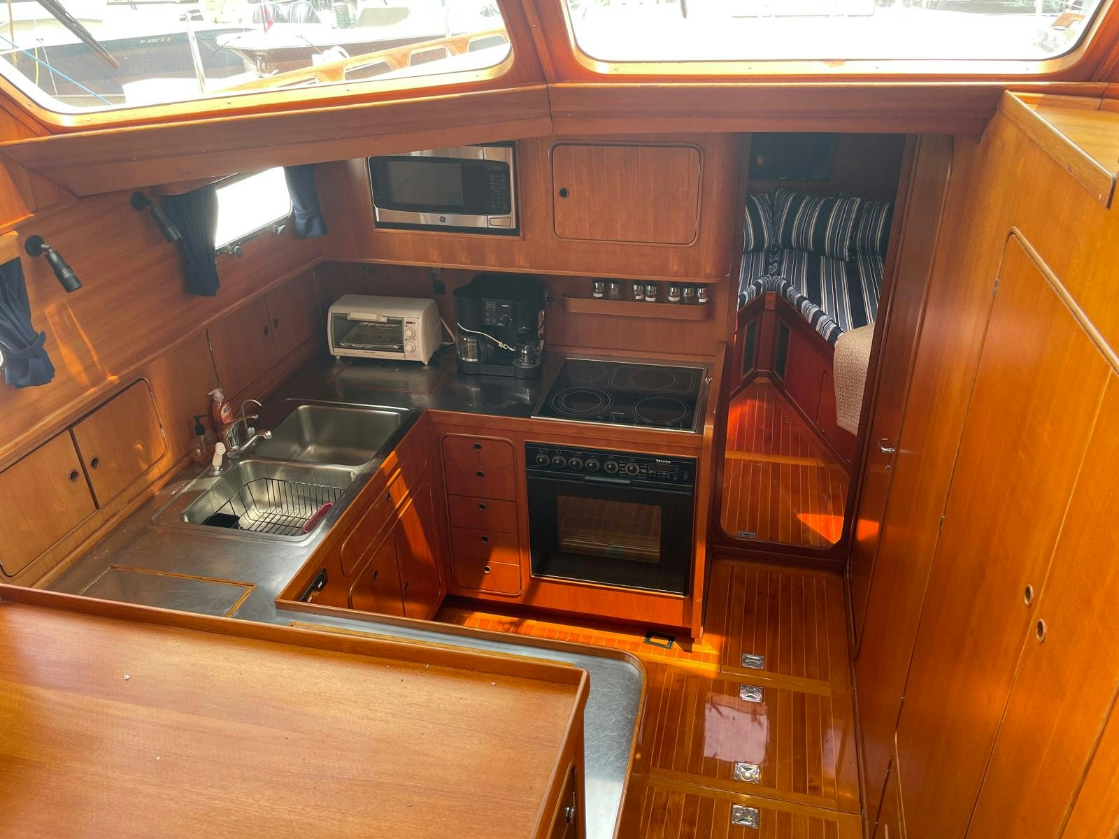 a kitchen with wooden cabinets aboard SOUTHERLY Yacht for Sale