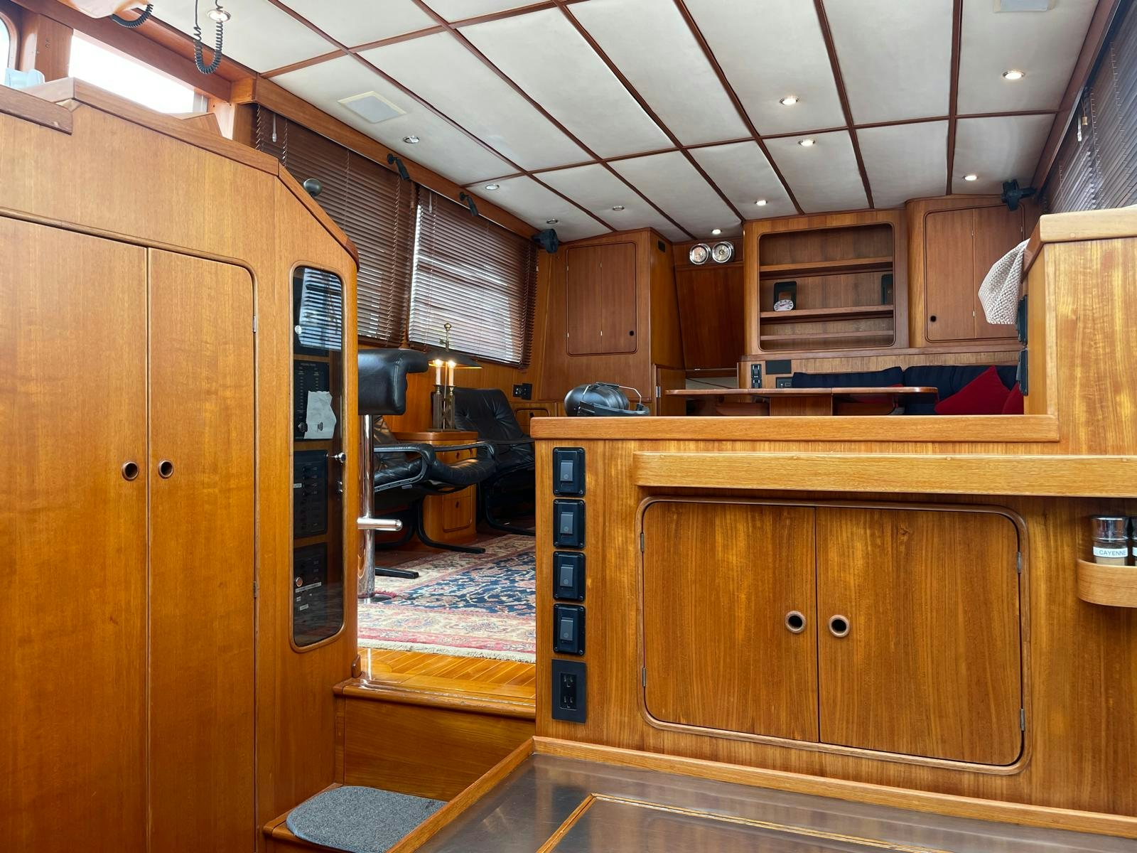 a kitchen with wooden cabinets aboard SOUTHERLY Yacht for Sale
