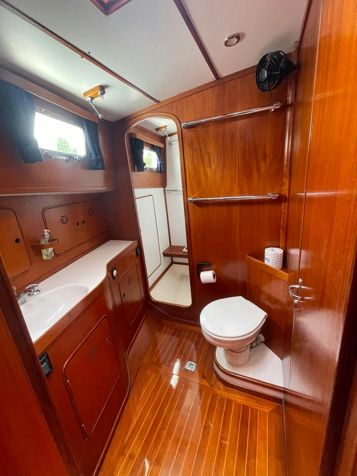 a bathroom with wooden cabinets aboard SOUTHERLY Yacht for Sale
